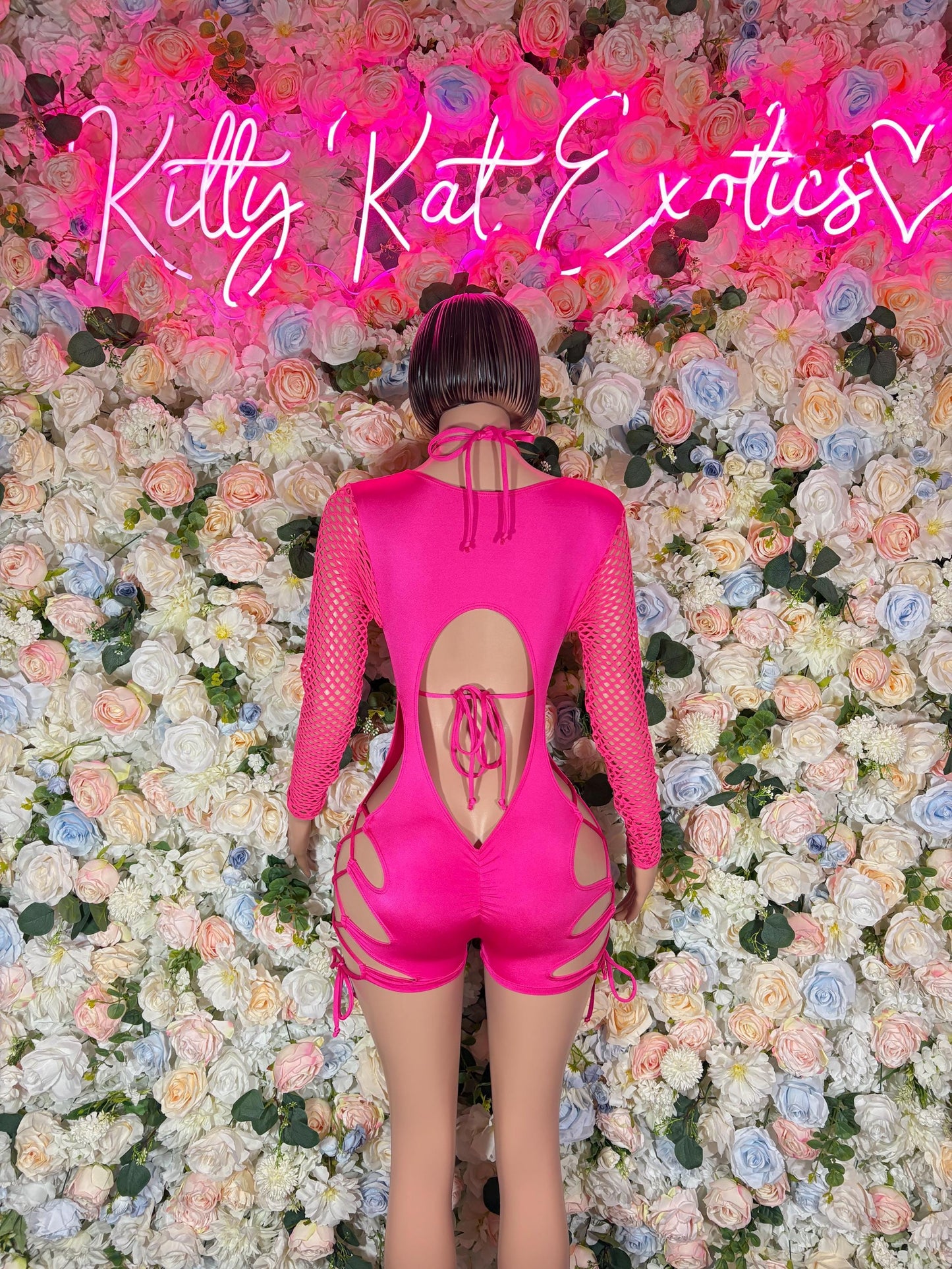 Pink backless one-piece bodysuit with lace-up detail and open cutout
