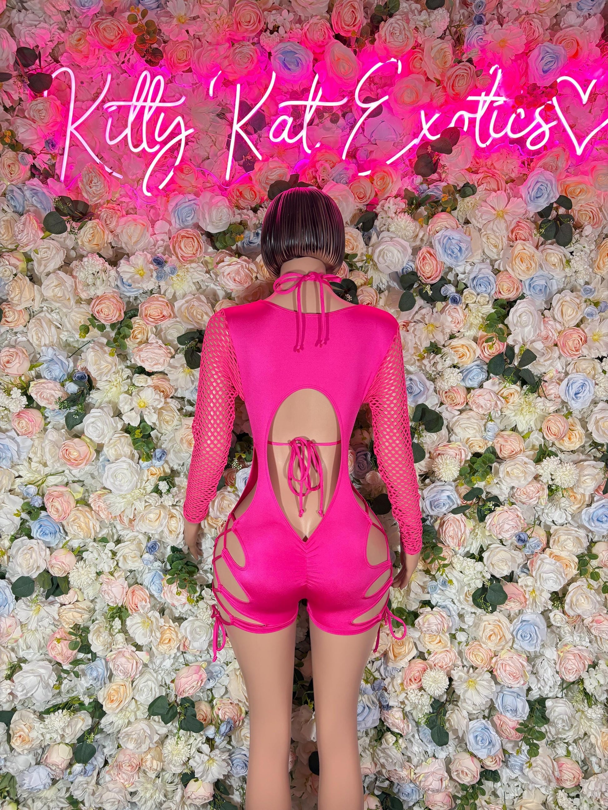 Pink backless one-piece bodysuit with lace-up detail and open cutout
