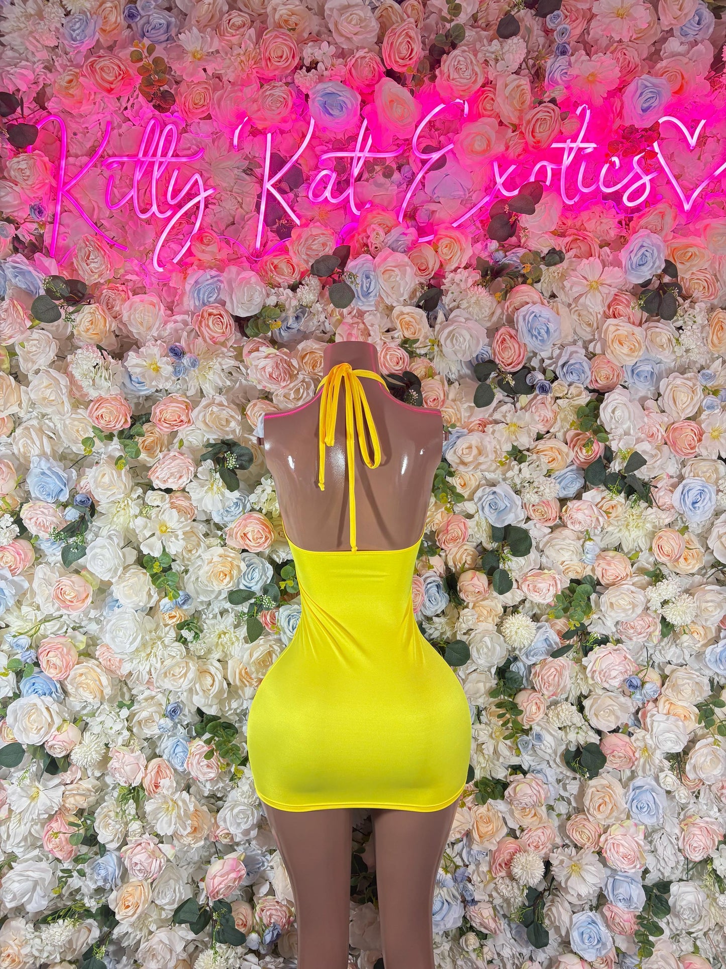 Neon yellow halter mini dress with open back and bow tie shoulder straps