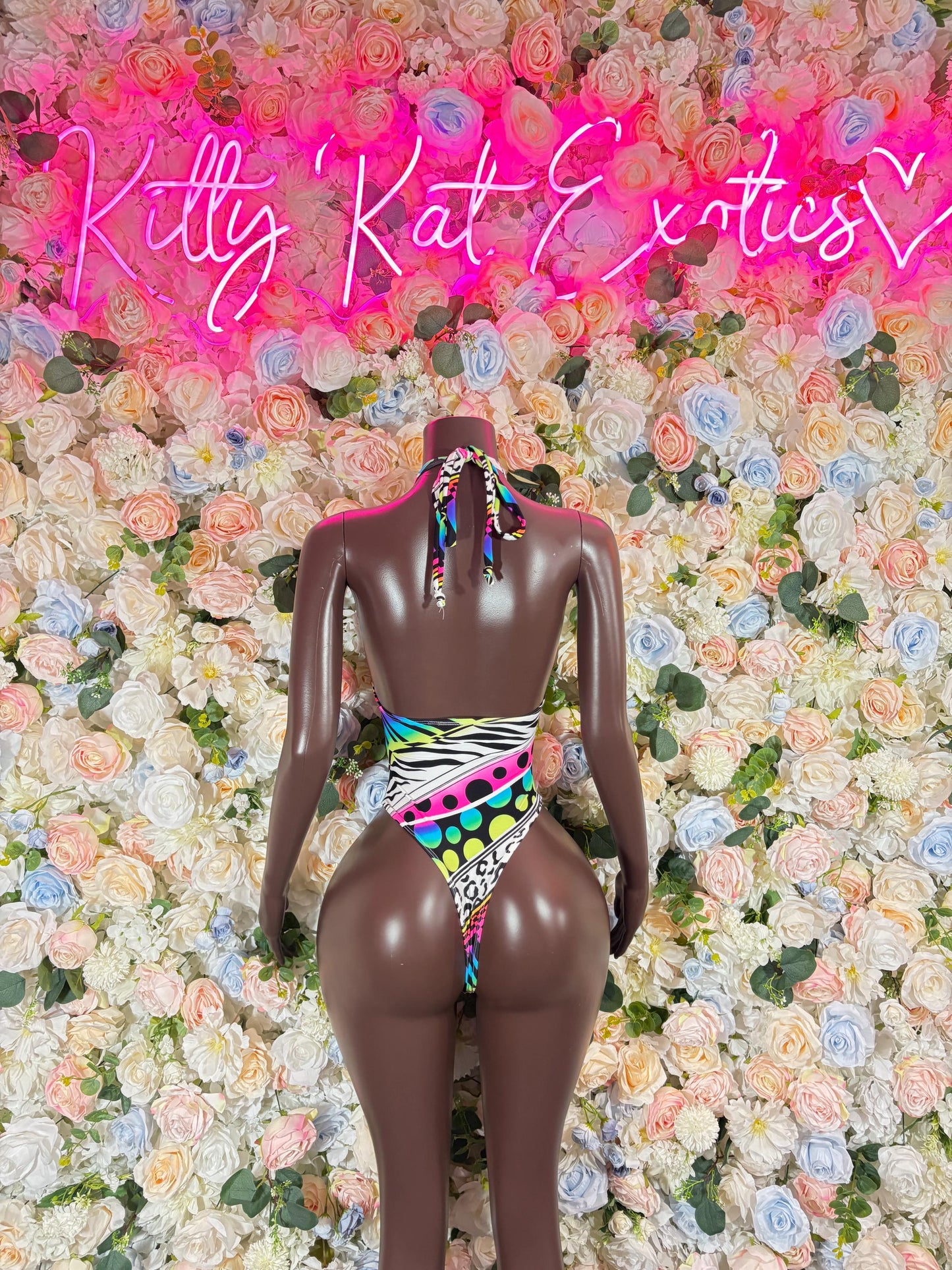 Multicolor one-piece bodysuit with geometric rainbow print, backless cutout