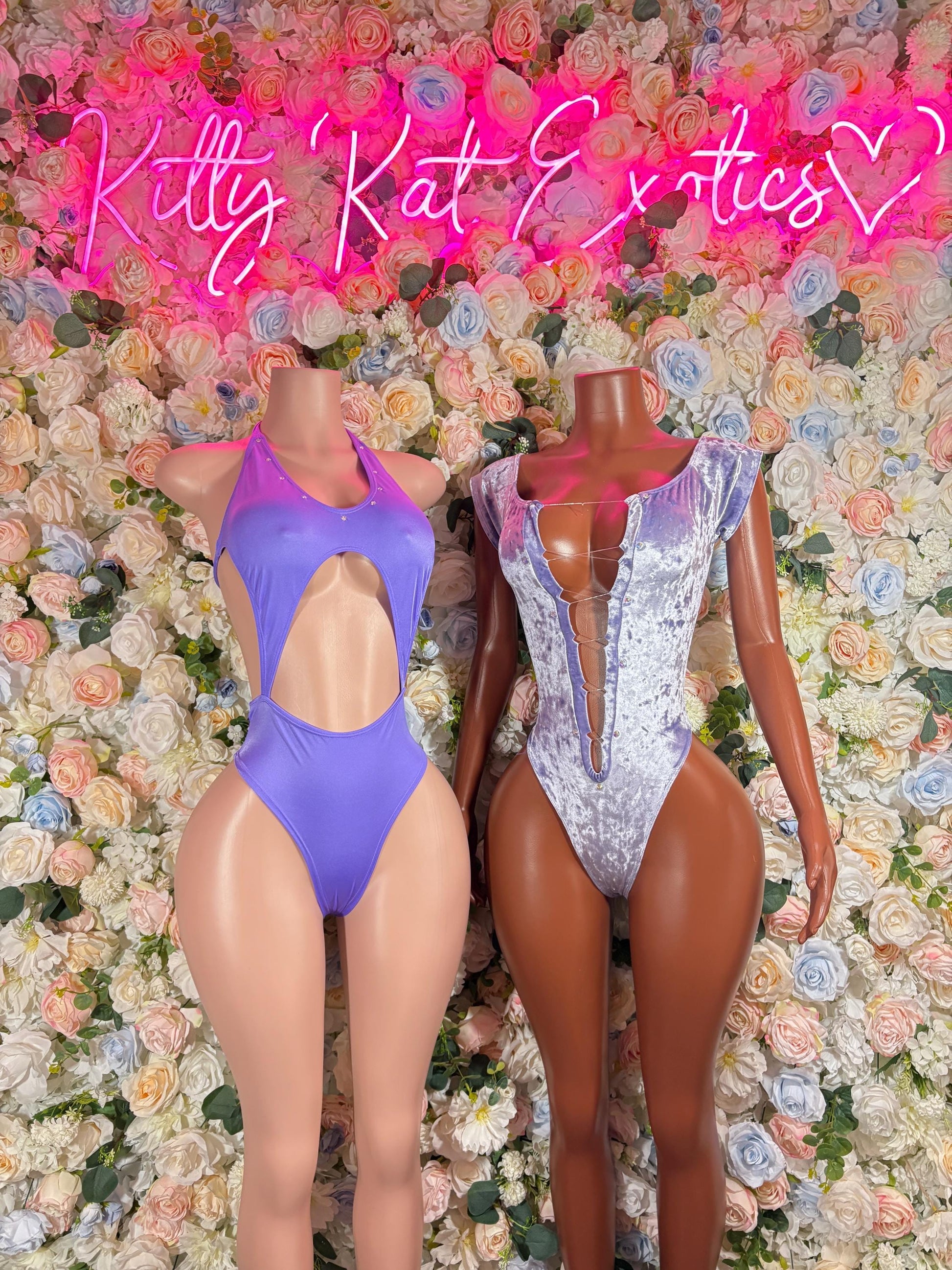 Purple one-piece bodysuit with halter neckline, open back, and high-cut leg openings