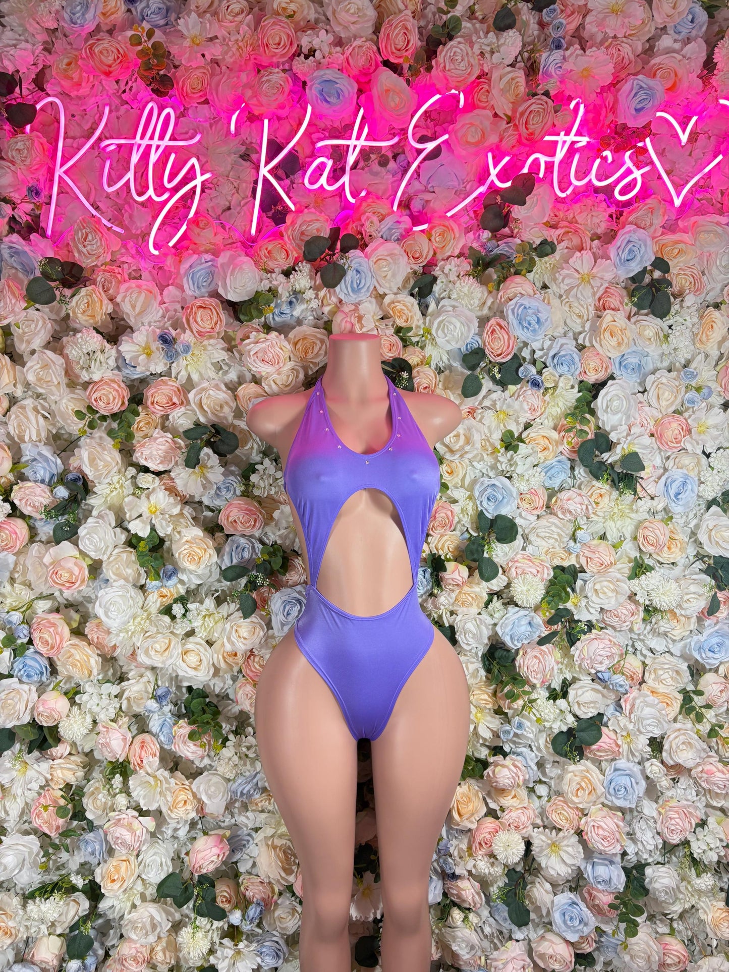 Purple one-piece bodysuit with halter neckline and high-cut leg openings