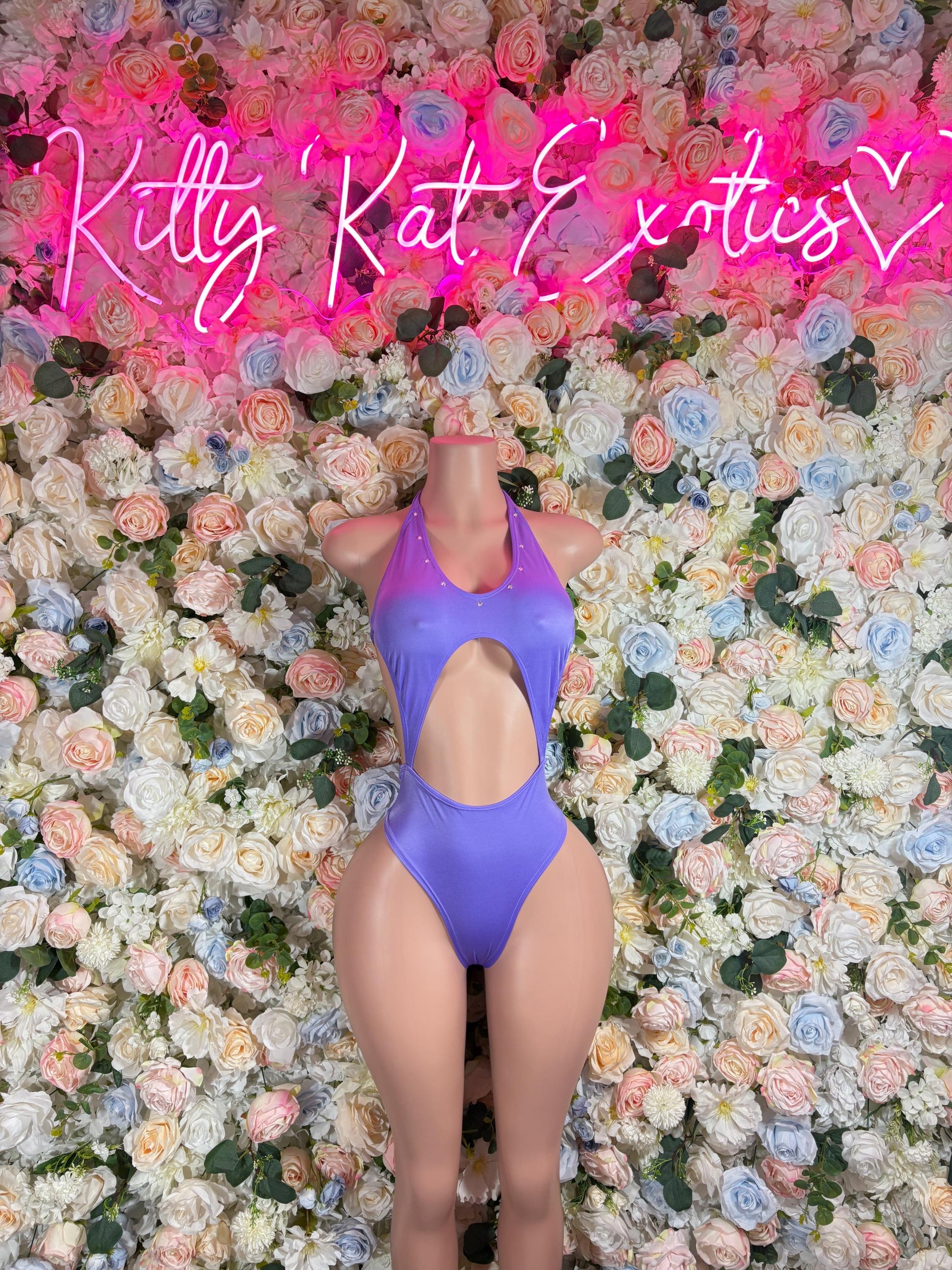 Purple one-piece bodysuit with halter neckline and high-cut leg openings