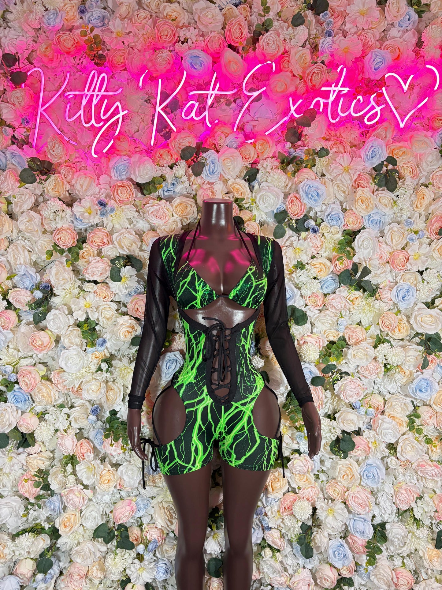 Black one-piece bodysuit with neon green mesh pattern and cutout details