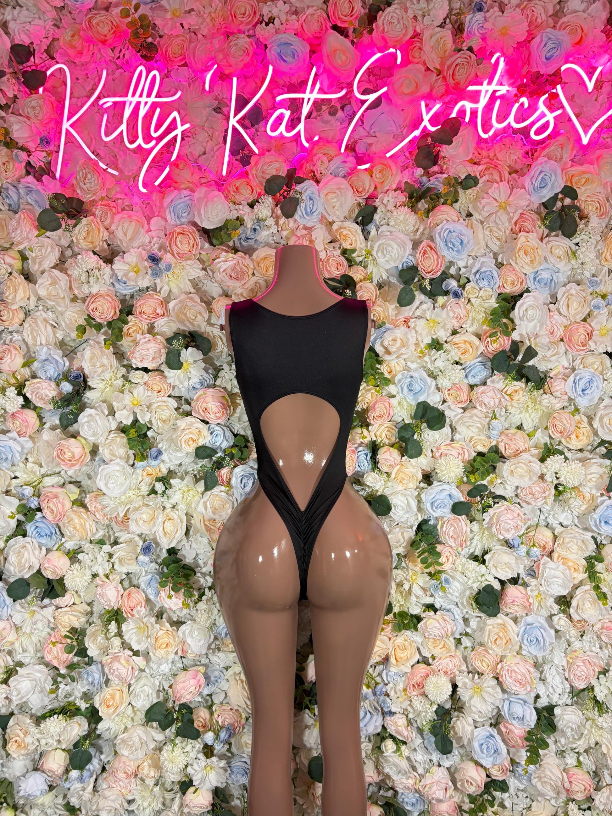 Black one-piece bodysuit with sheer panels and large teardrop cutout front