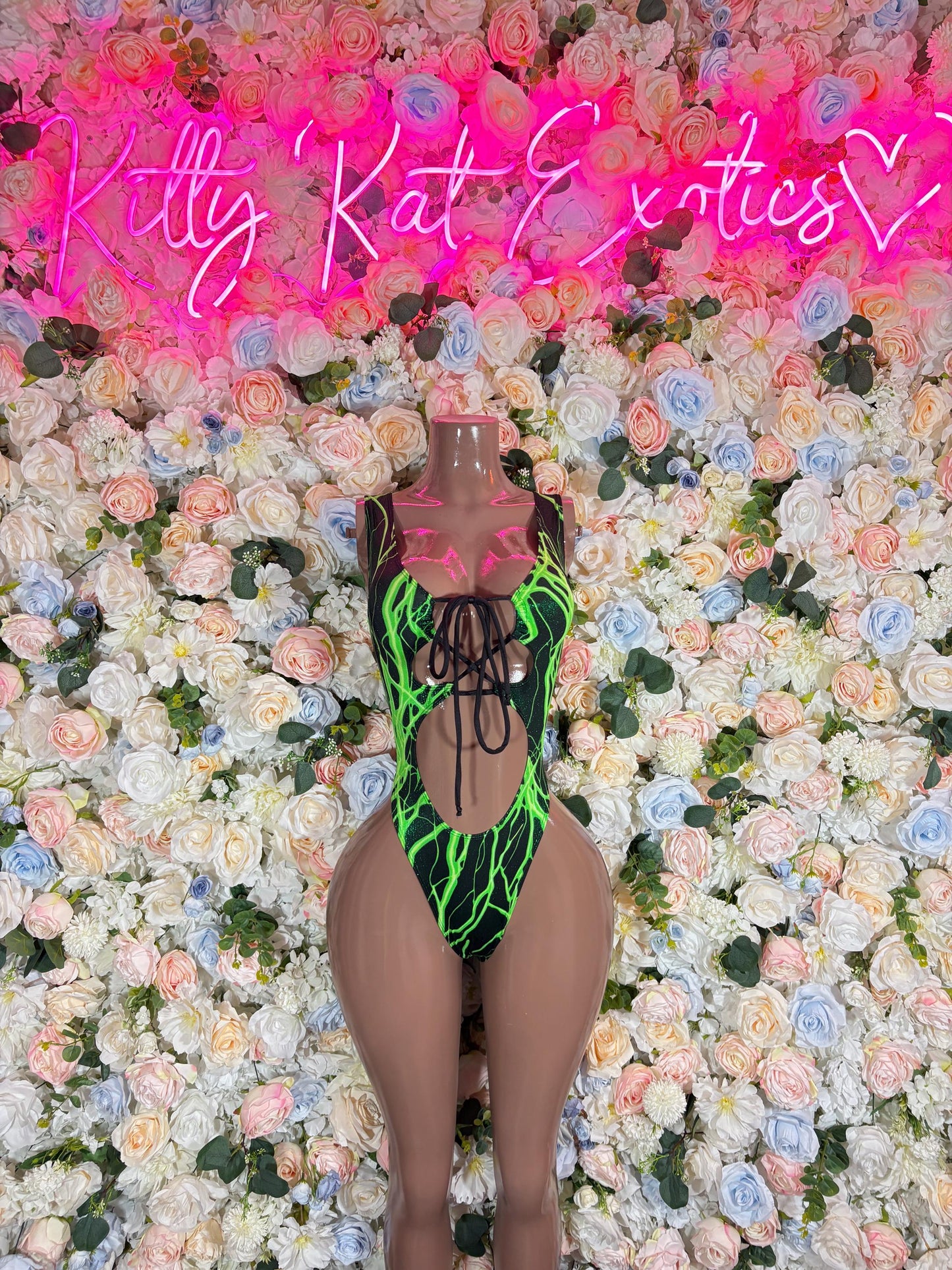 Black mesh one-piece bodysuit with neon green electric pattern and cutout front