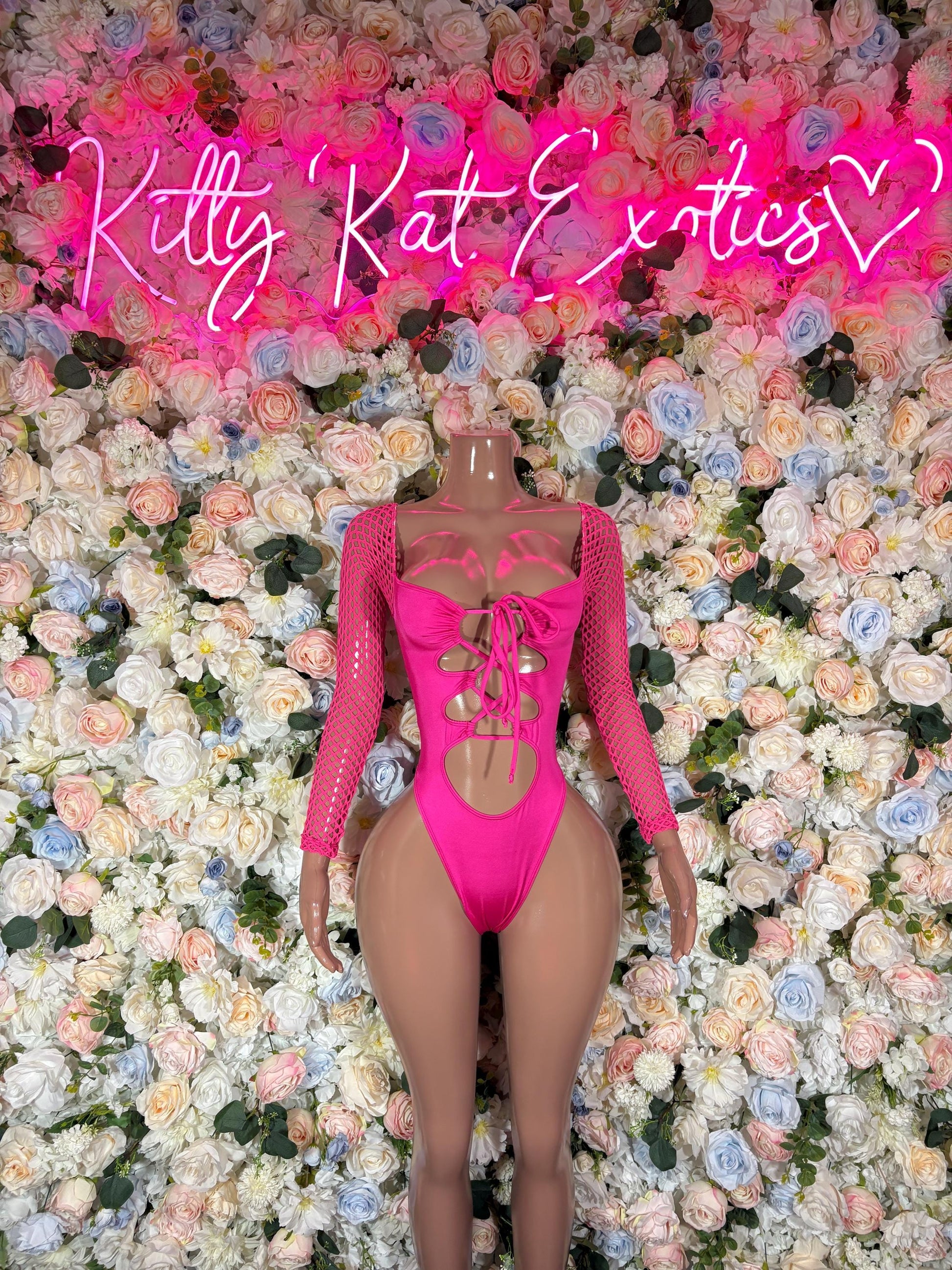 Pink backless lace-up bodysuit with sheer long sleeves and cutout back straps