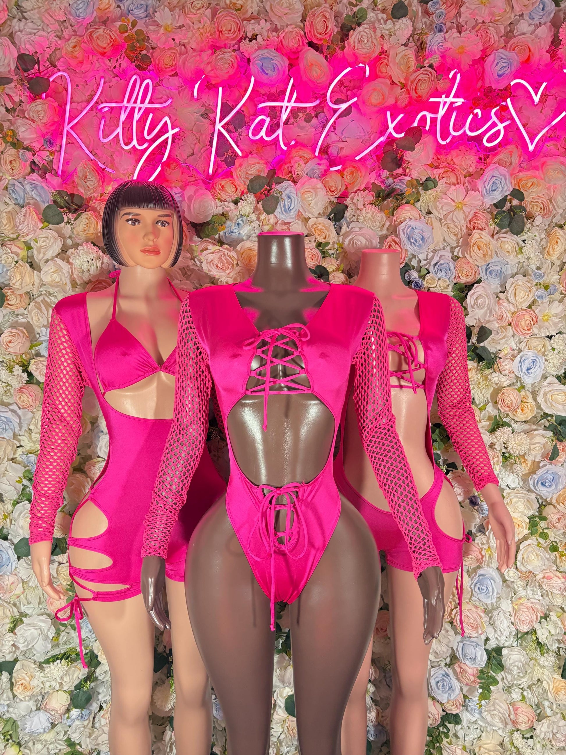 Pink bodysuit with mesh sleeves, front cutouts, and central lace-up chest