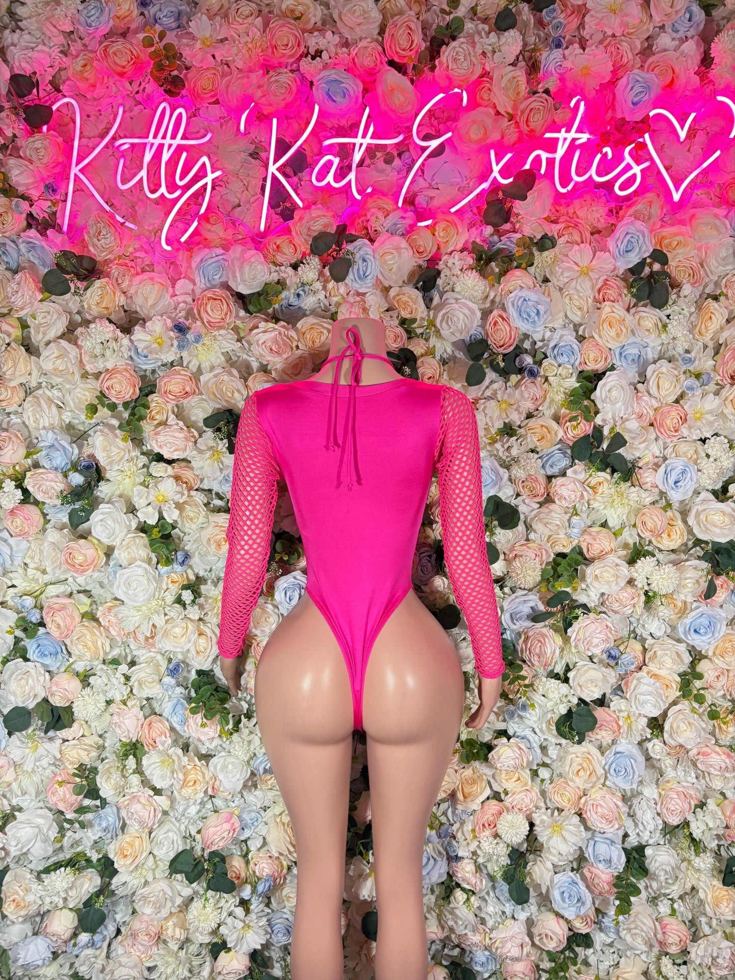 Pink mesh bodysuit with tie-back, thong cut, and center front cutout detail