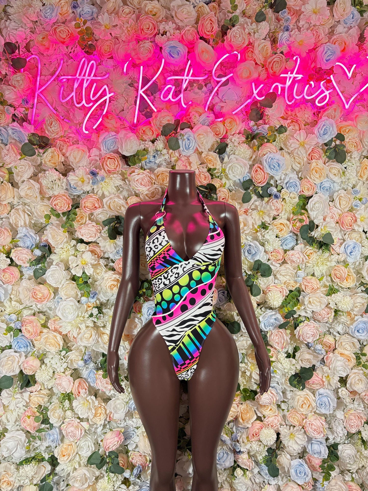 Multicolor one-piece bodysuit with geometric rainbow print and halter tie