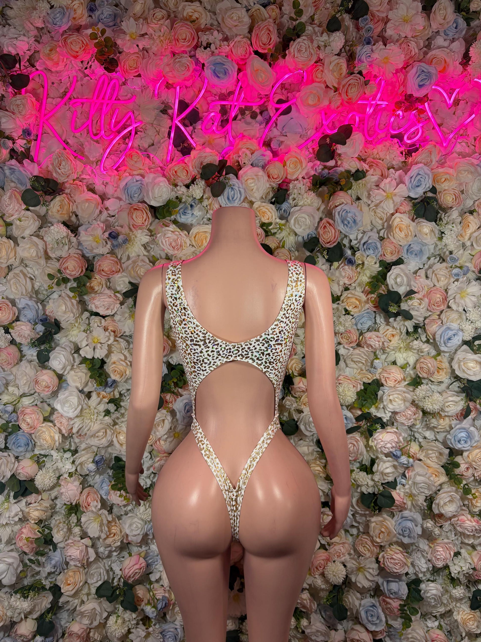 Cheetah-print open-back bodysuit with crisscross straps and cheeky coverage