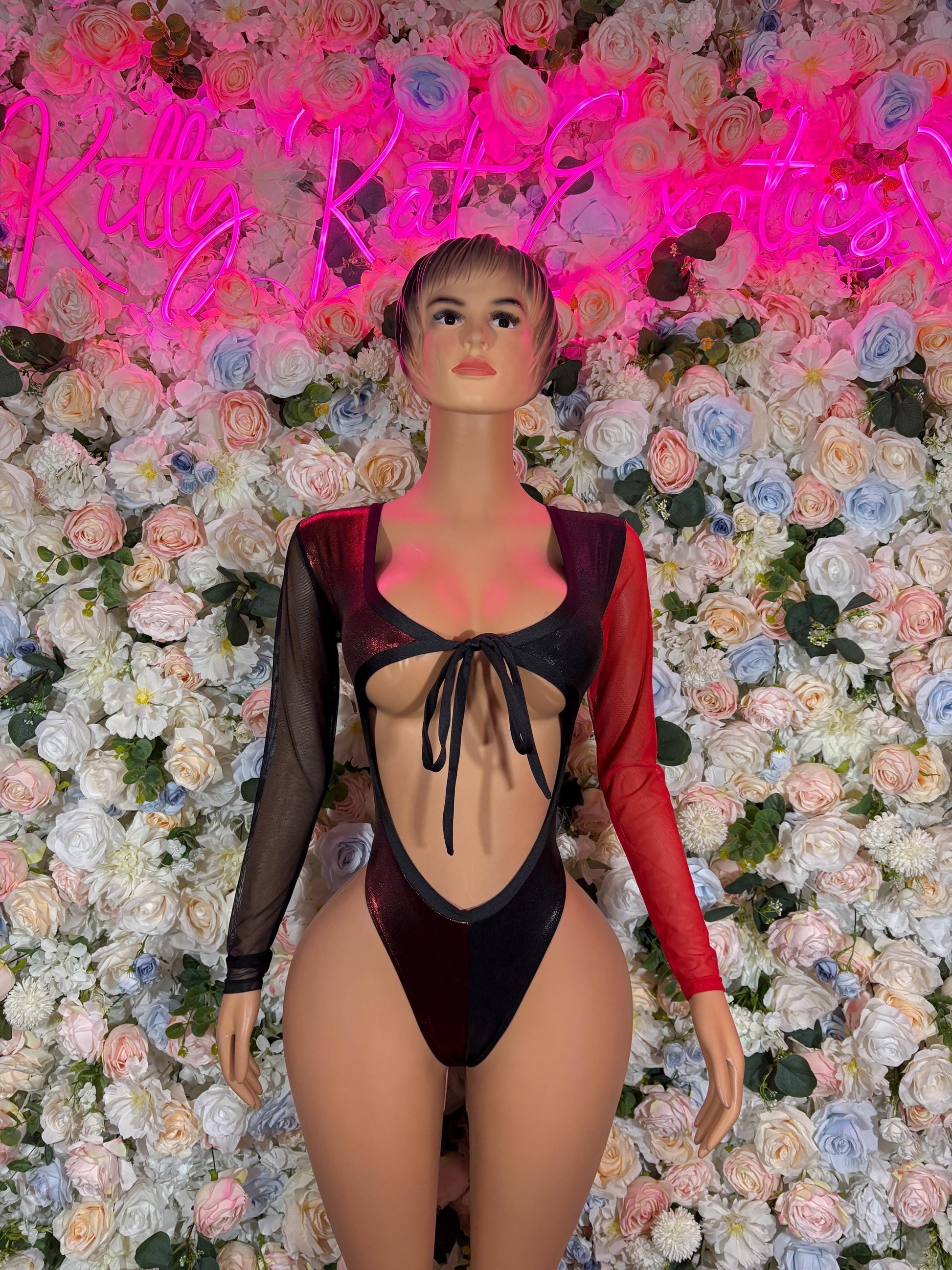Black lace-up bodysuit costume with red sleeves, long sheer arms and open back