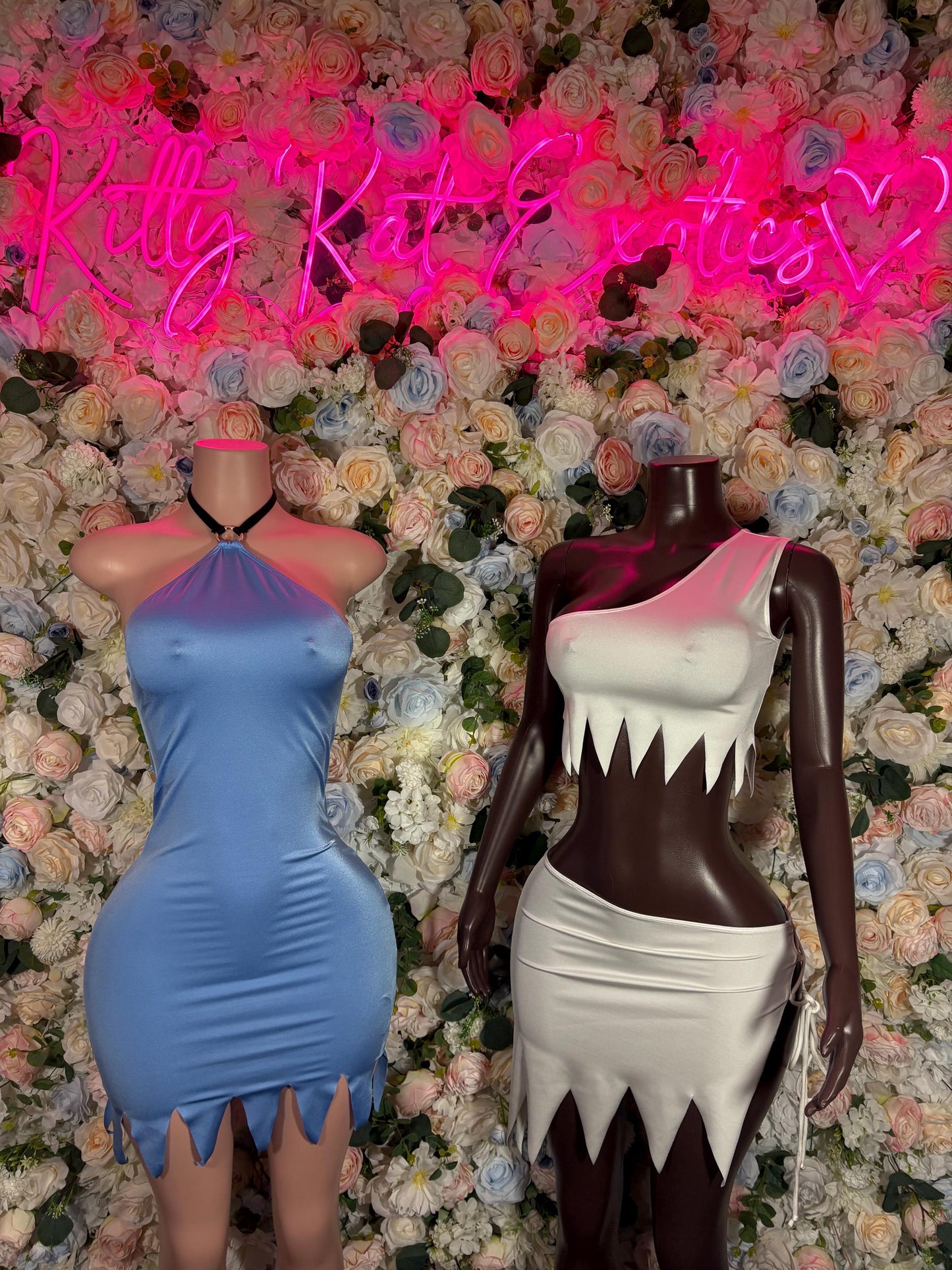 Halloween cosplay dress on mannequins: light blue sleeveless dress and dark-and-white dress