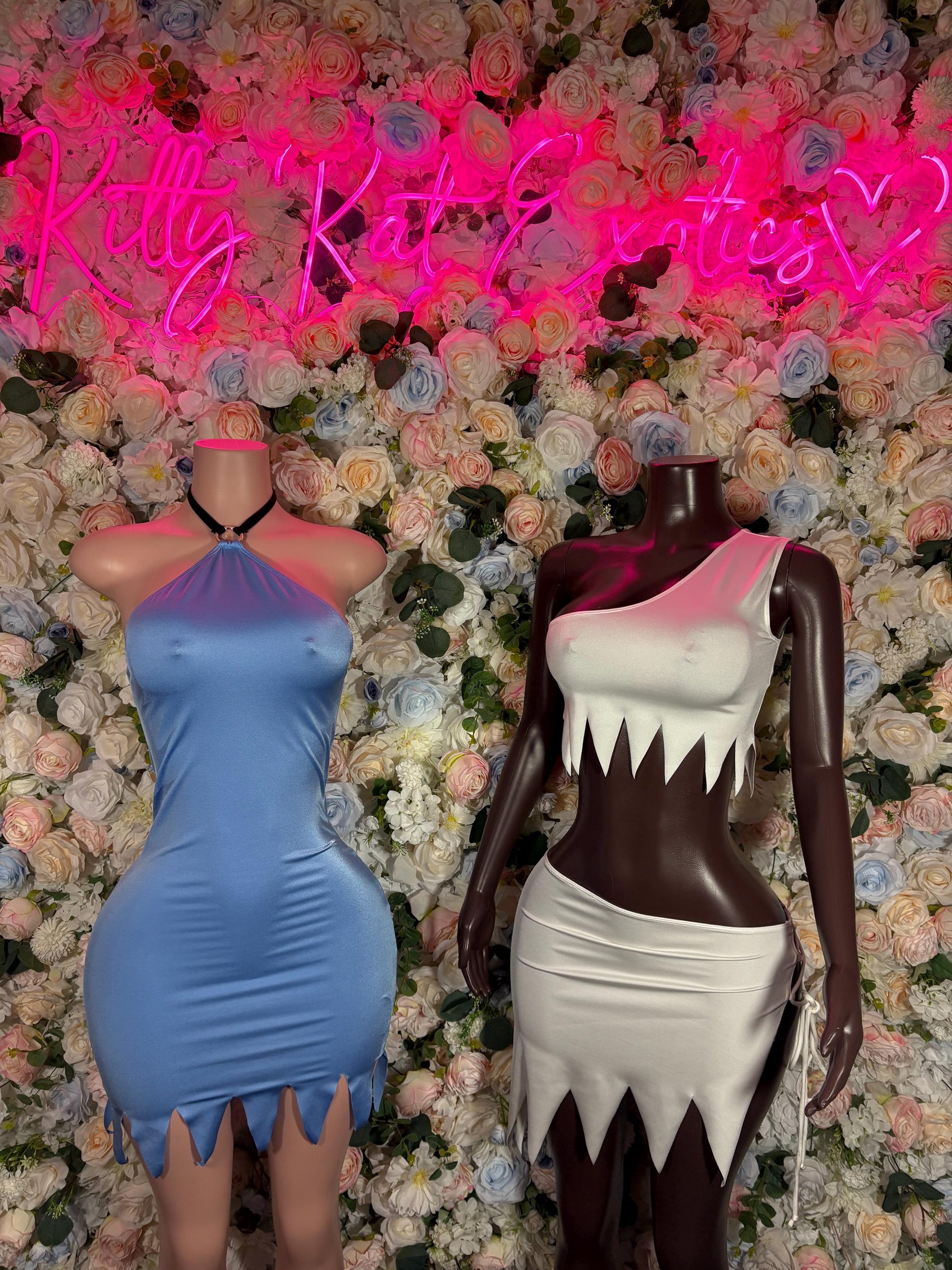 Halloween cosplay dress on mannequins: light blue sleeveless dress and dark-and-white dress