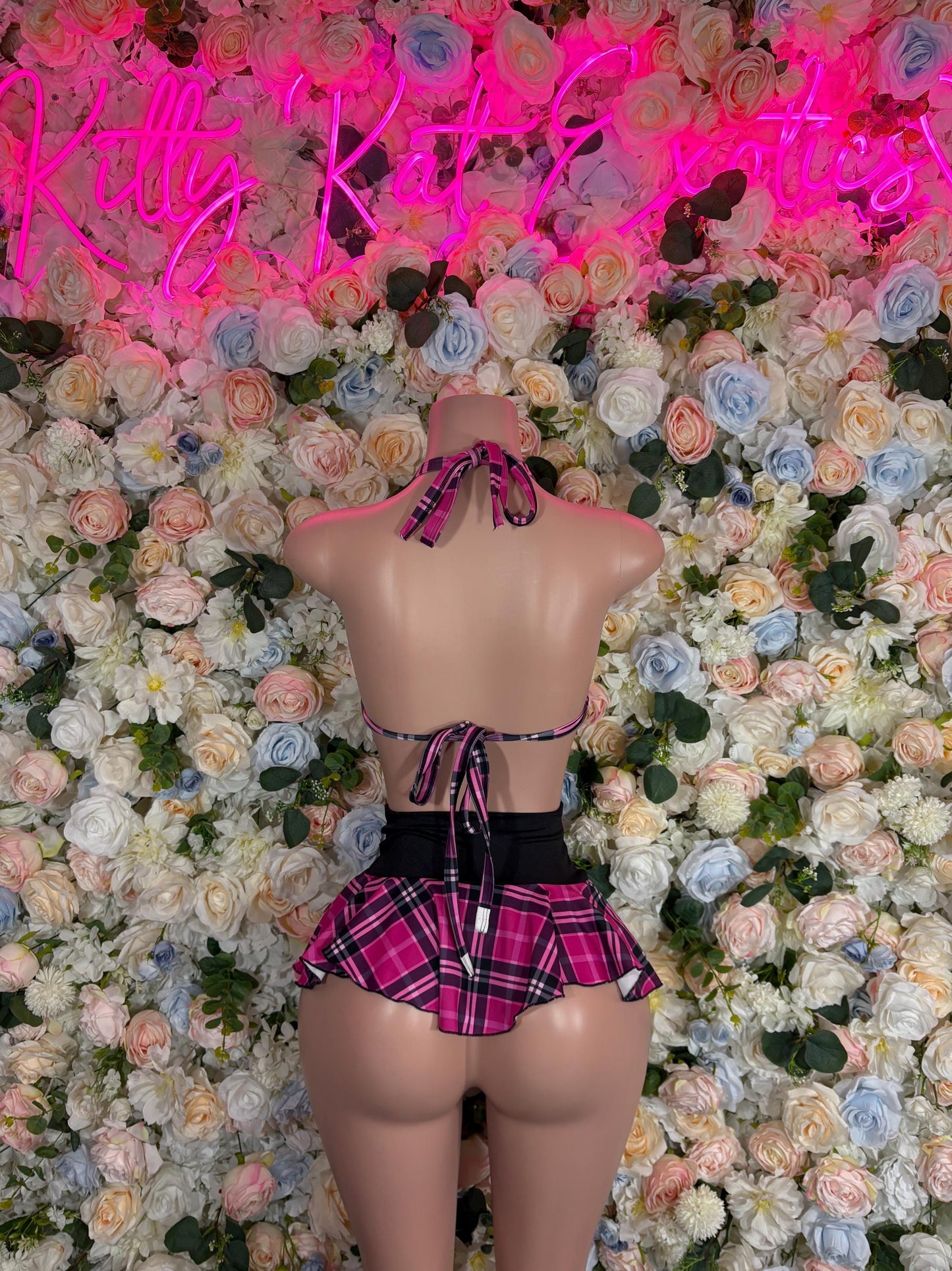 Women’s plaid skirt set back view: black bralette with pink plaid skirt