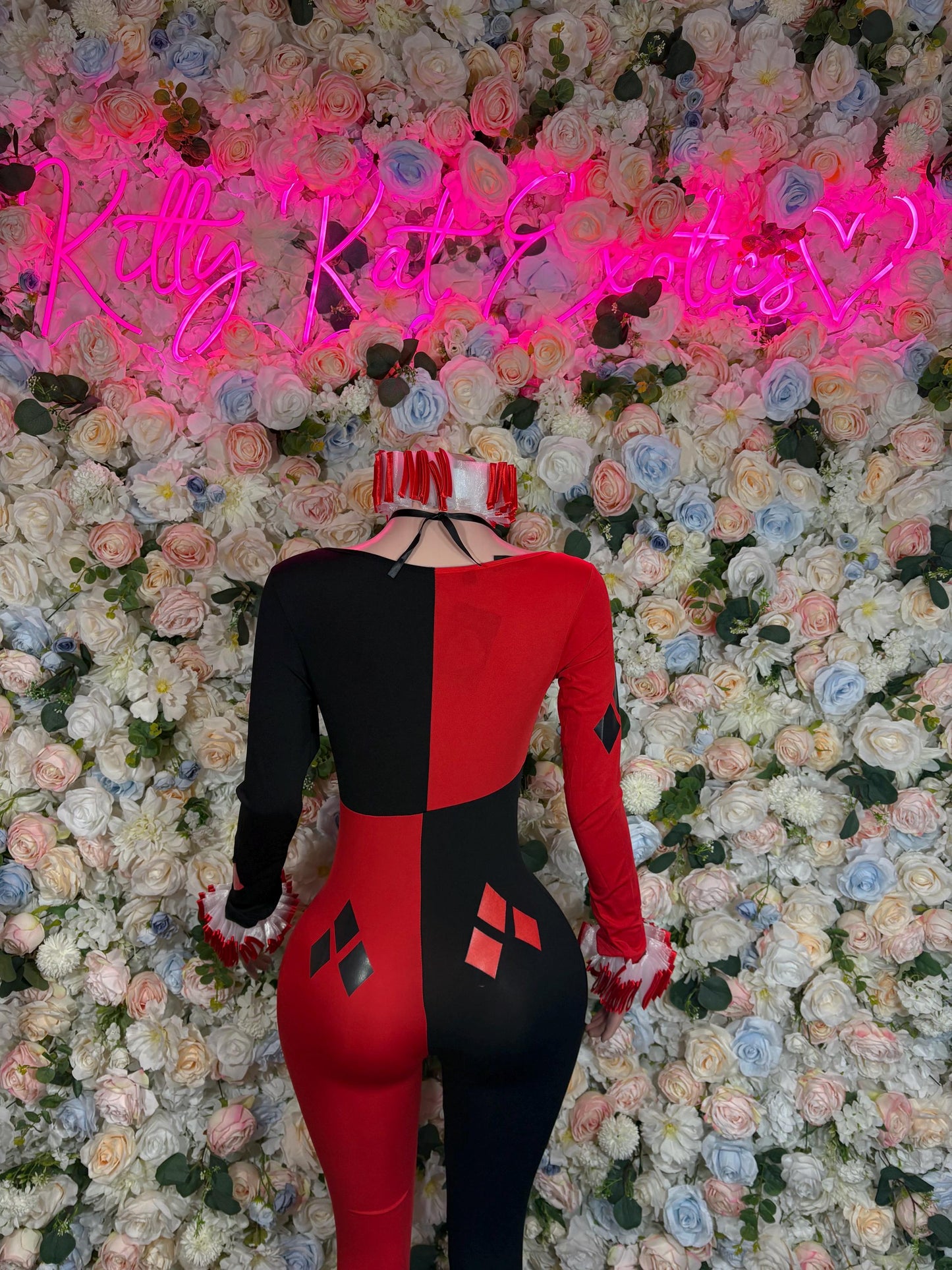 Women’s harlequin-style costume, red and black fitted bodysuit with diamond patches, back