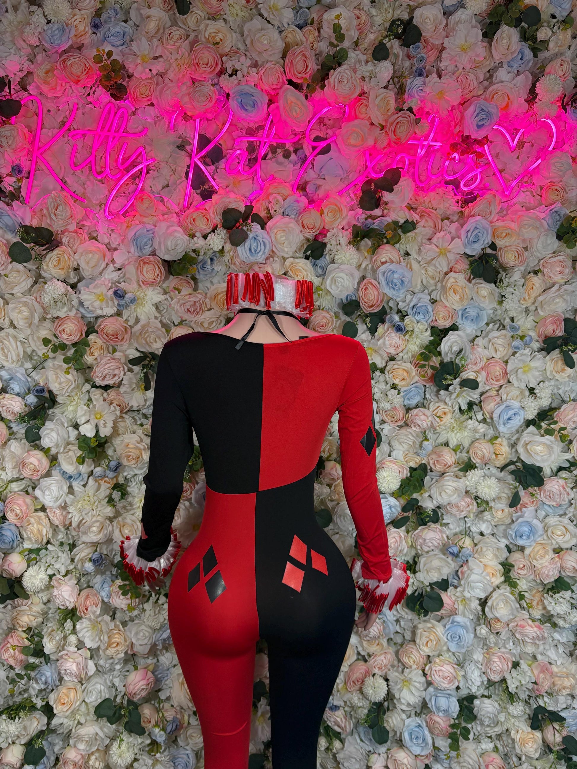 Women’s harlequin-style costume, red and black fitted bodysuit with diamond patches, back