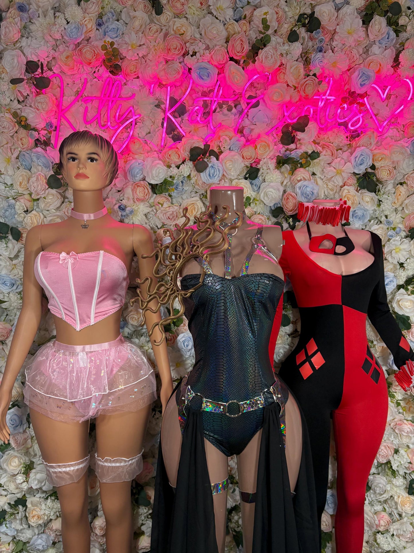 Women’s harlequin-style costume on mannequin, red and black fitted bodysuit with ruffled collar