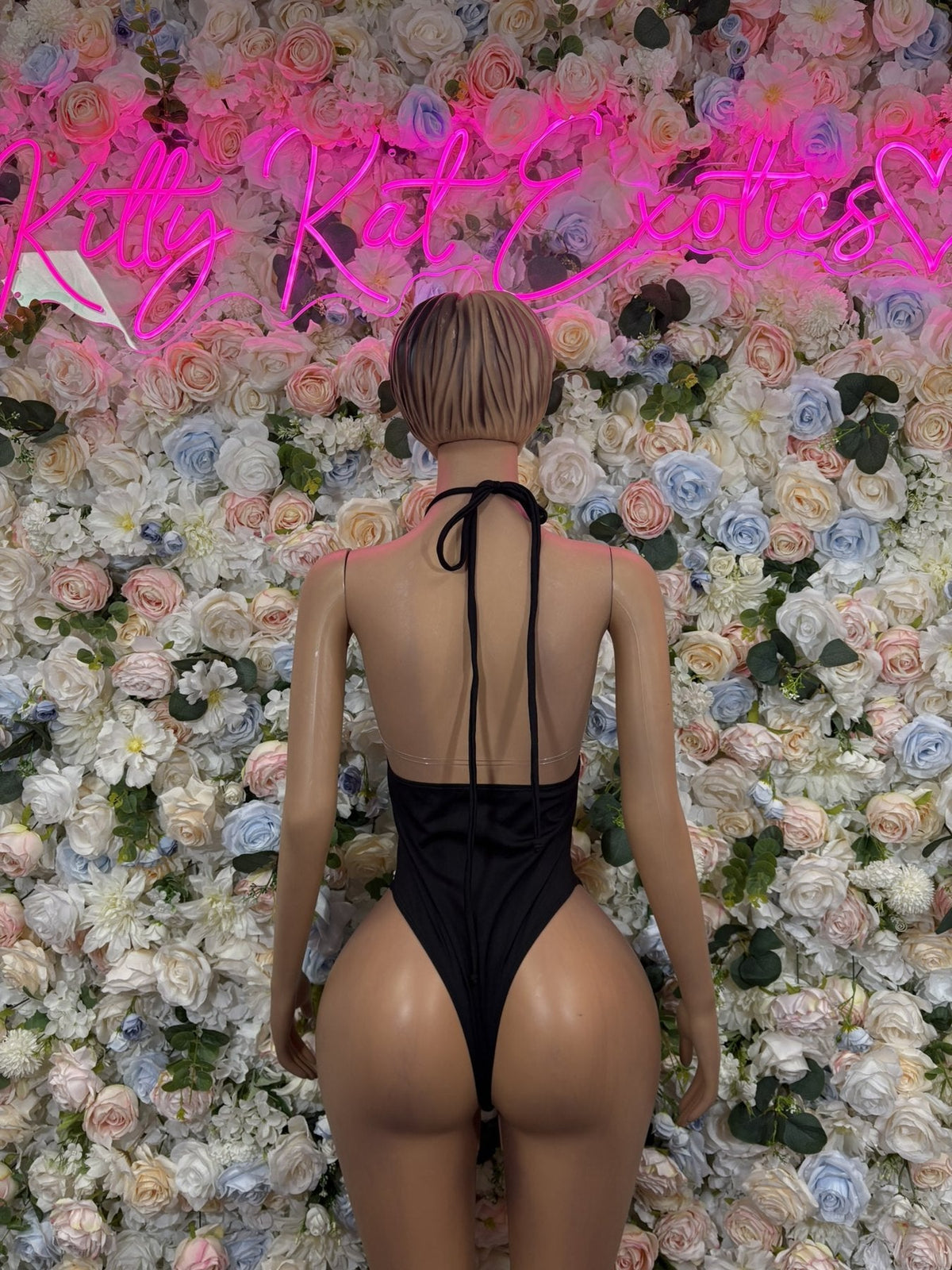 Black halter one-piece bodysuit with open back and tie halter straps