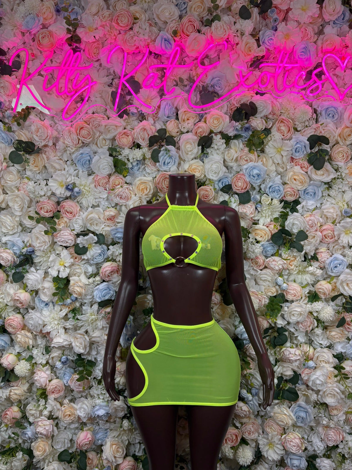 Lime green halter two-piece skirt set with keyhole cutout, mini skirt, and strap details