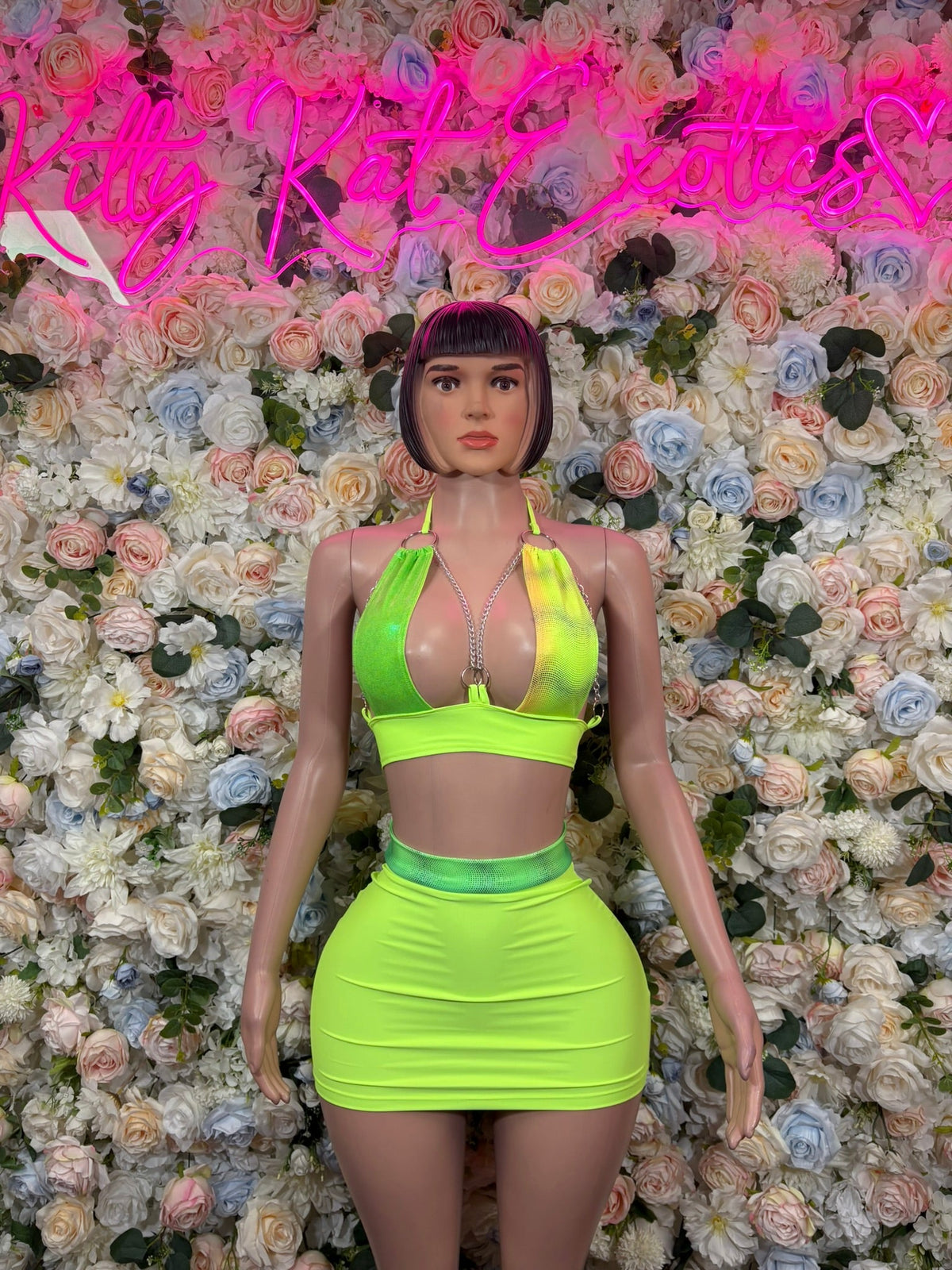 Neon lime green halter bralette top and ruched mini skirt, front view