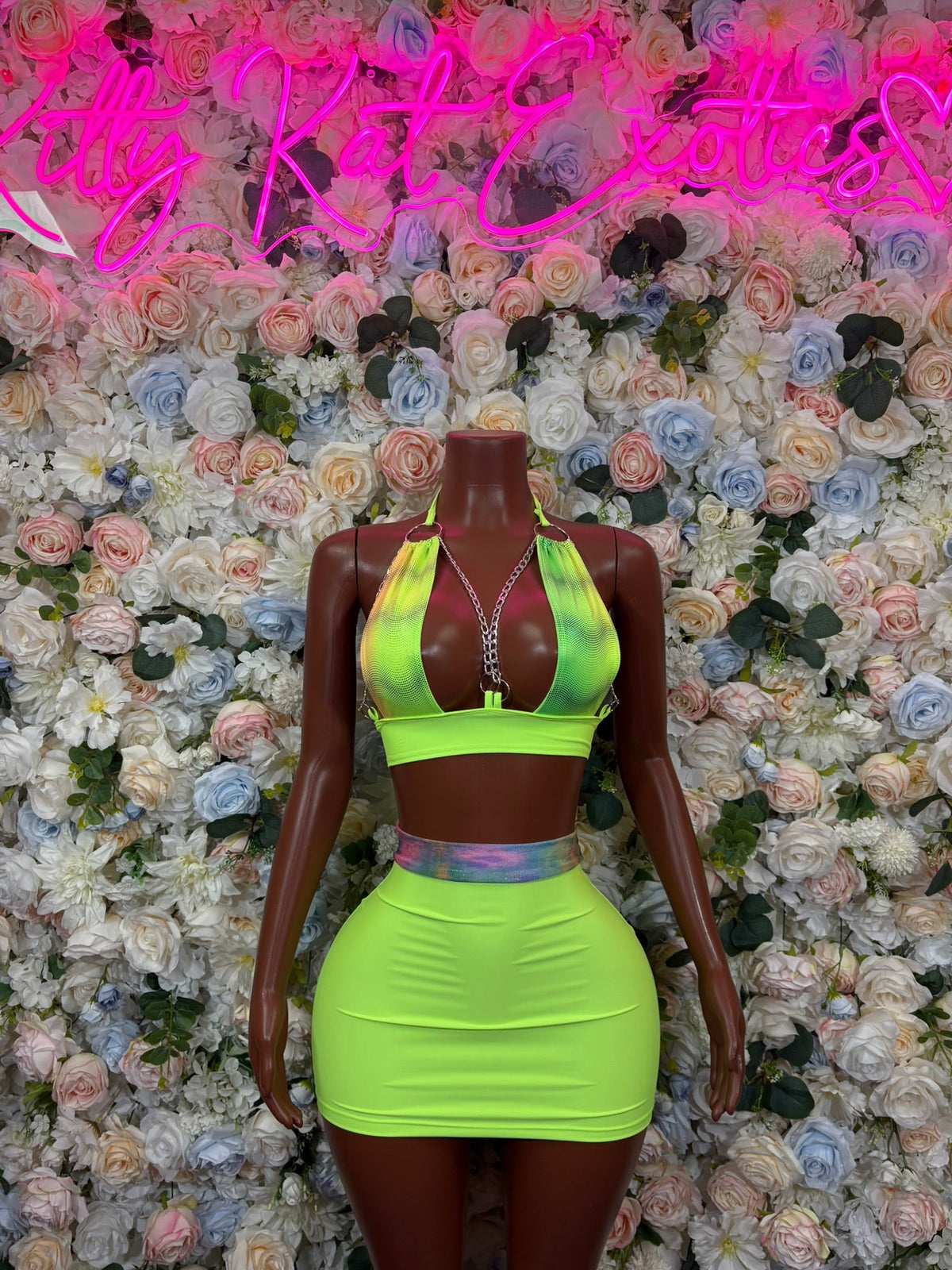 Lime green halter crop top and high waist mini skirt two-piece outfit, mannequin front view