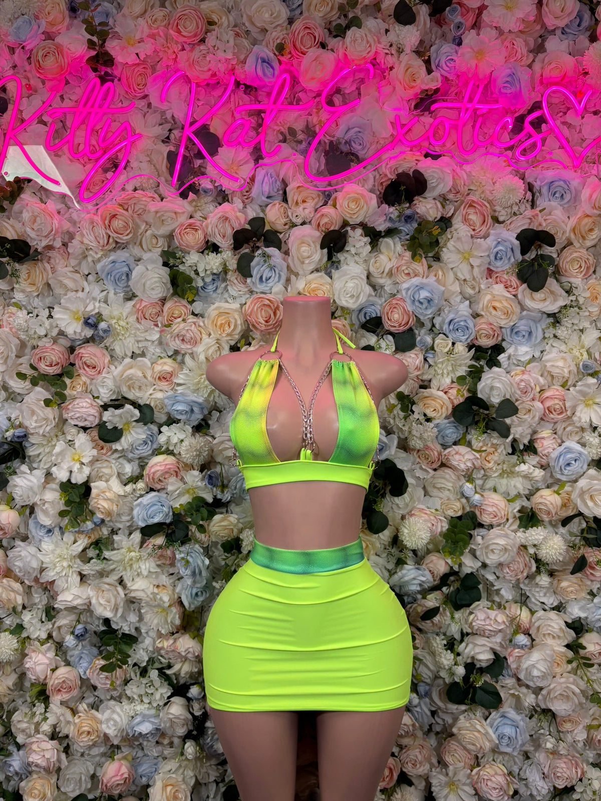 Neon green halter crop top with rhinestone straps and matching mini skirt