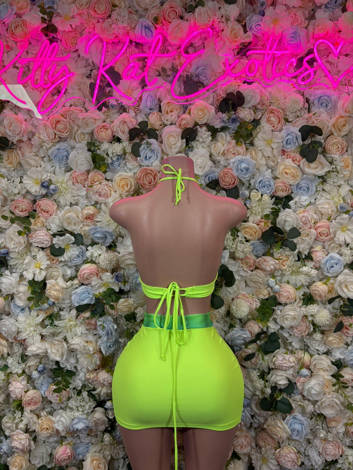 Neon green halter mini skirt set with tie-back and open-back crop top