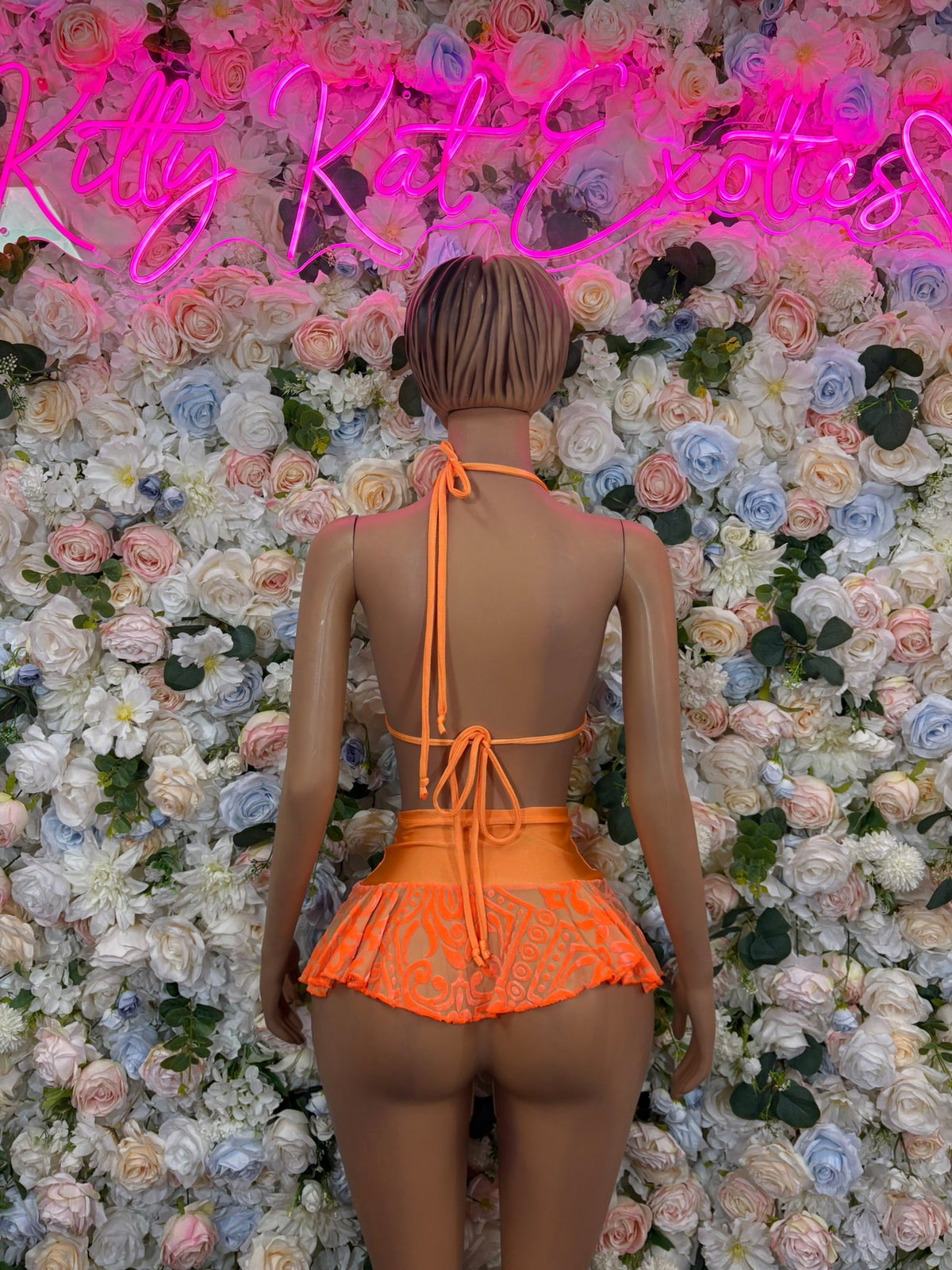 Orange patterned triangle ruffle skirt bikini set, back view with tie straps