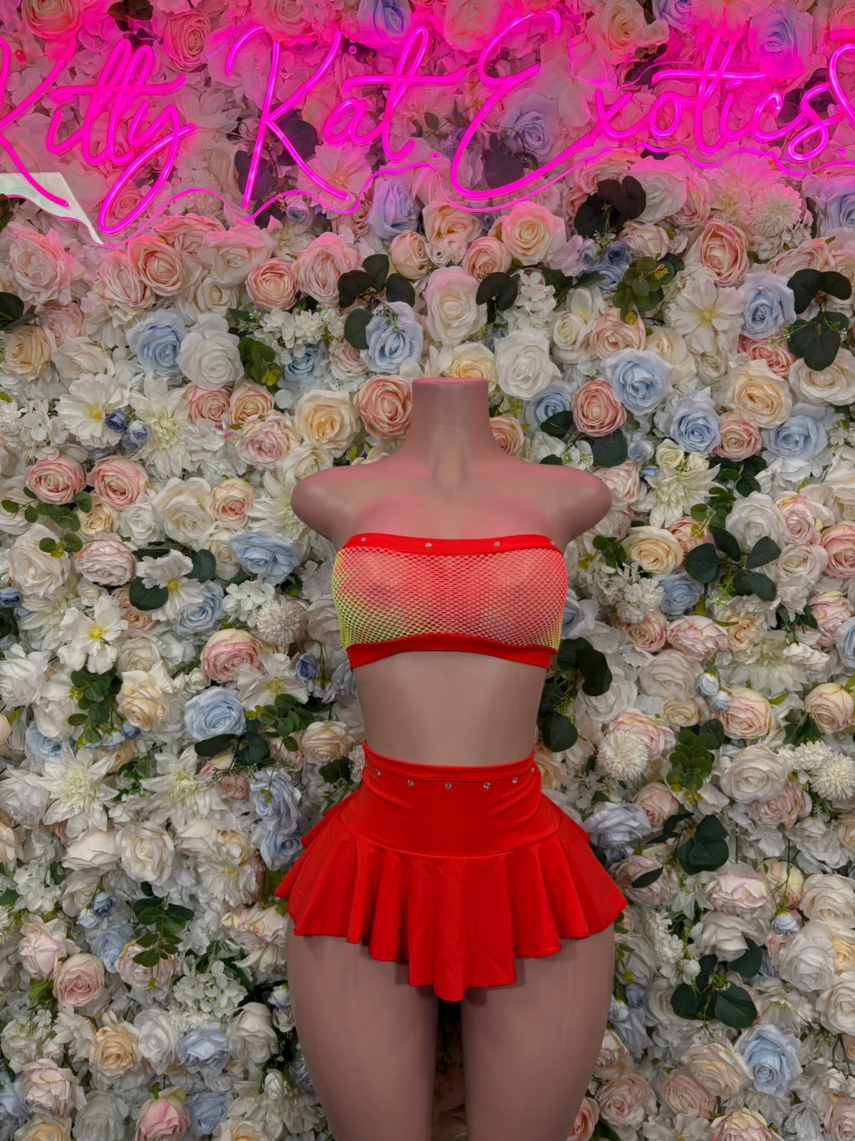 Red mesh bandeau and ruffled mini skirt set on mannequin, strapless back view