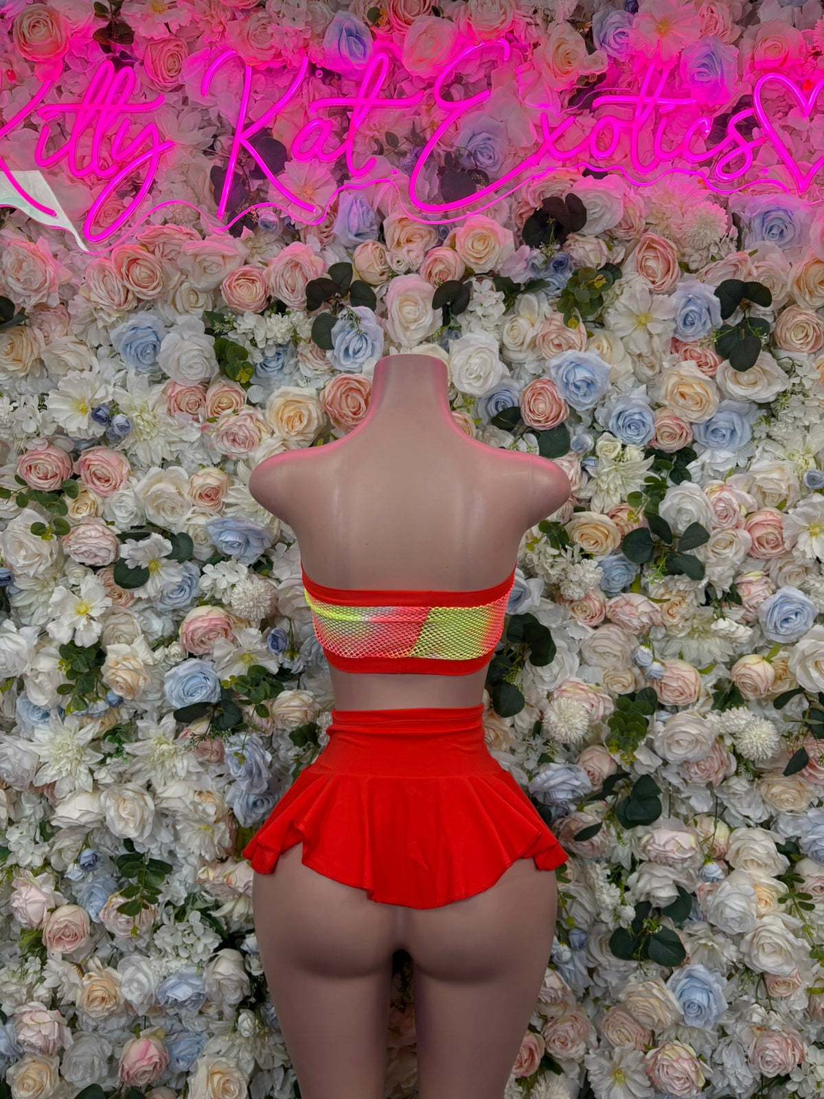 Red mesh bandeau with striped trim and ruffled mini skirt, mannequin view