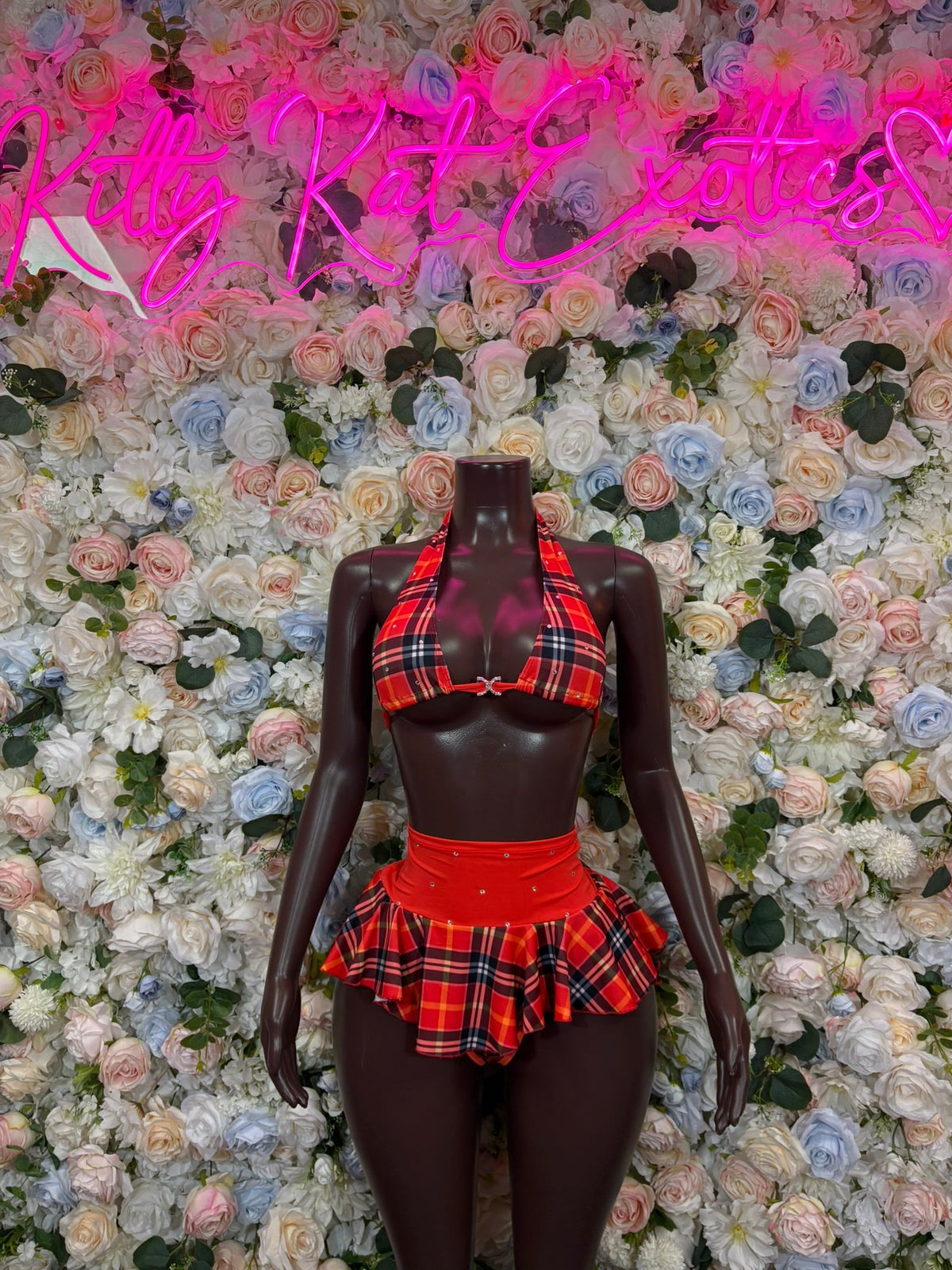 Red and black plaid keyhole halter crop top with pleated mini skirt on mannequin