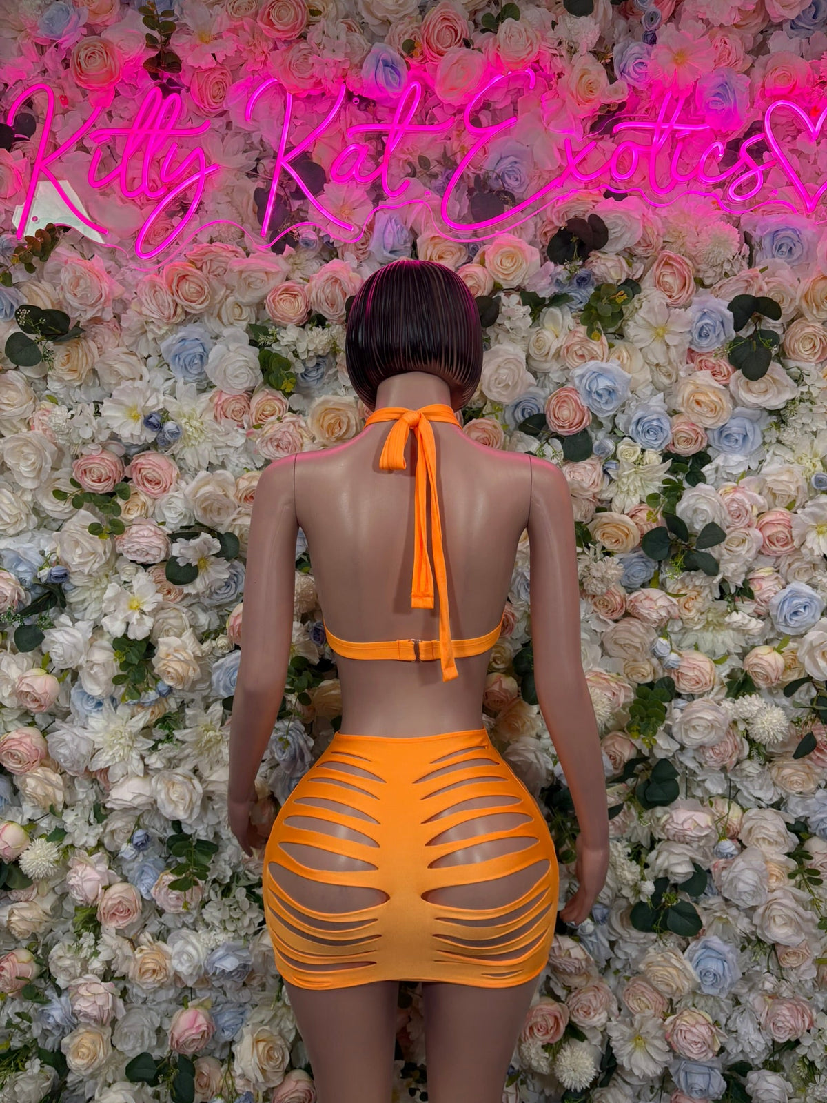 Orange halter mini skirt set with open back tie and striped cutout mini skirt