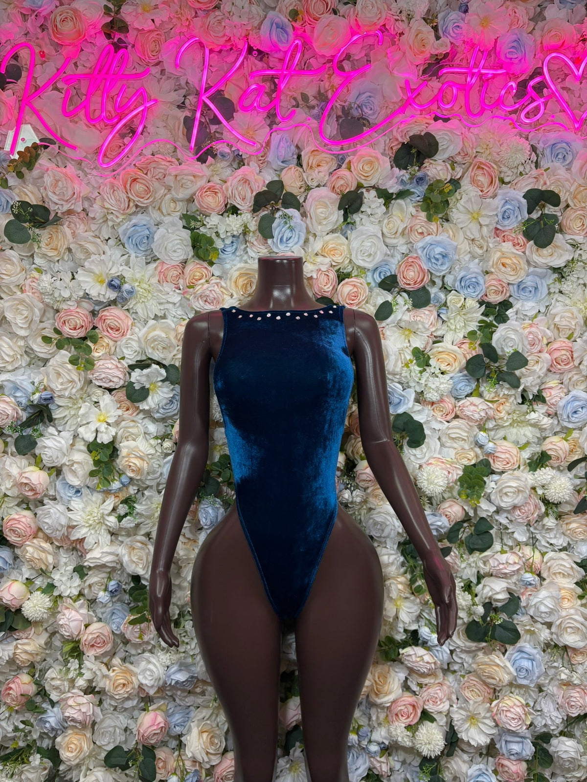 Deep blue high-neck long-sleeve bodysuit on mannequin, ruched velvet look
