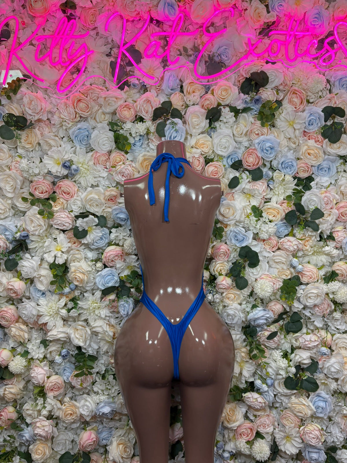 Royal blue crossover strap bodysuit with crisscross back straps and high-cut legs