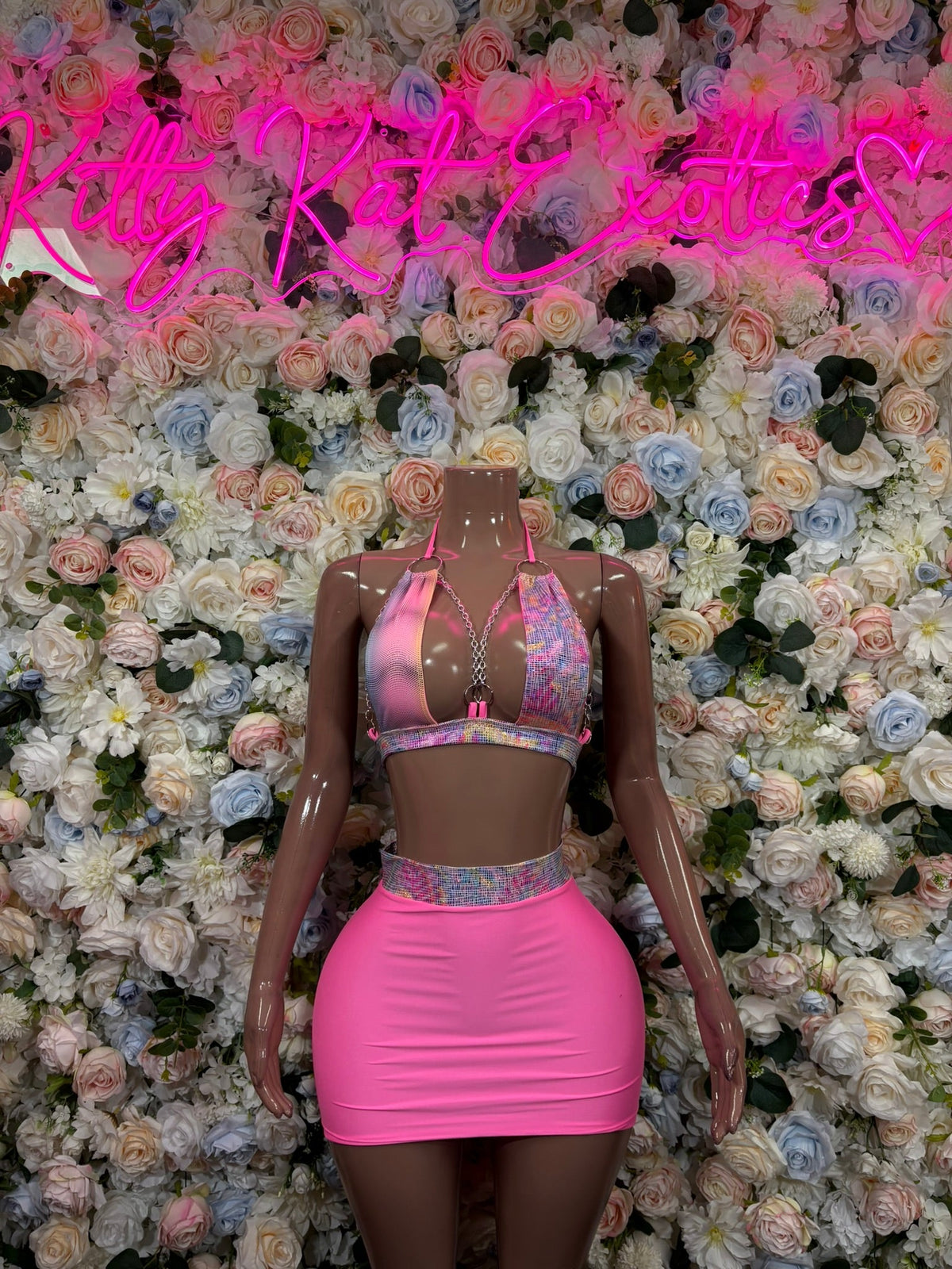Pink halter crop top and mini skirt set with multicolor patterned back panel, back view