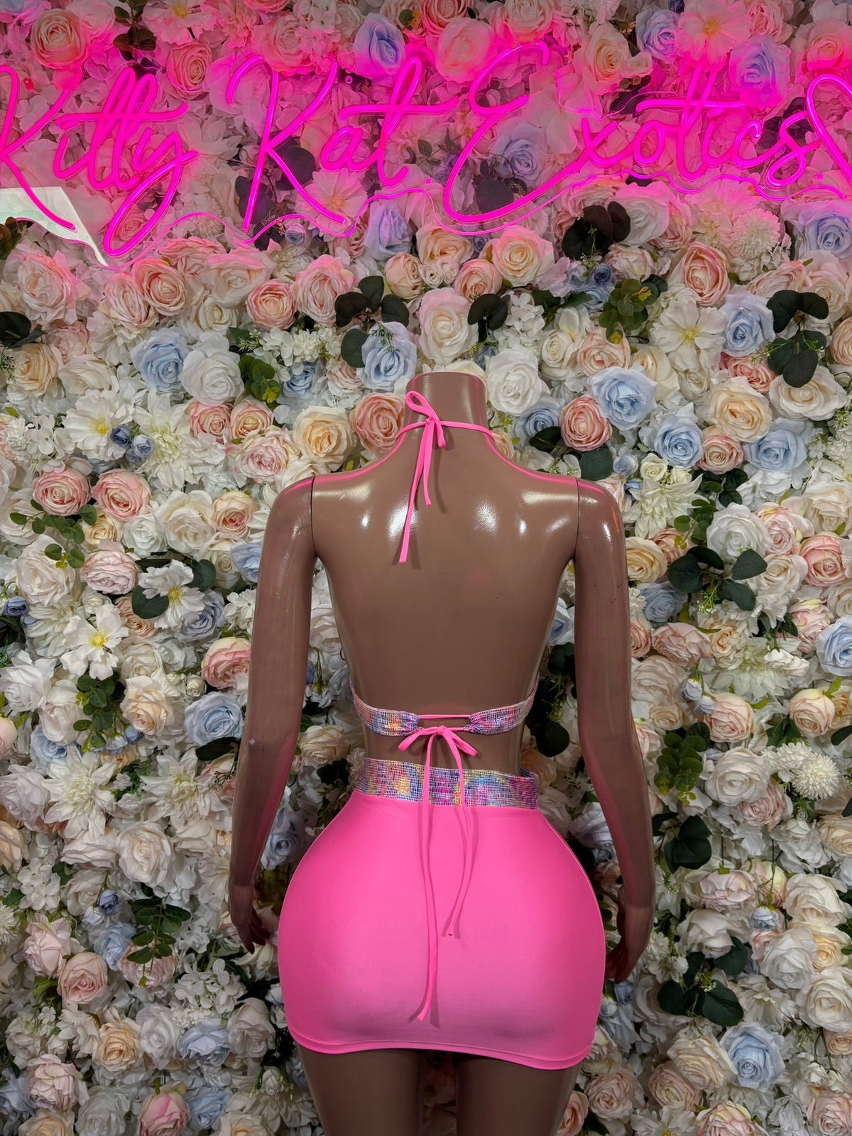 Pink halter mini skirt set with patterned crop top and ruched skirt, back view