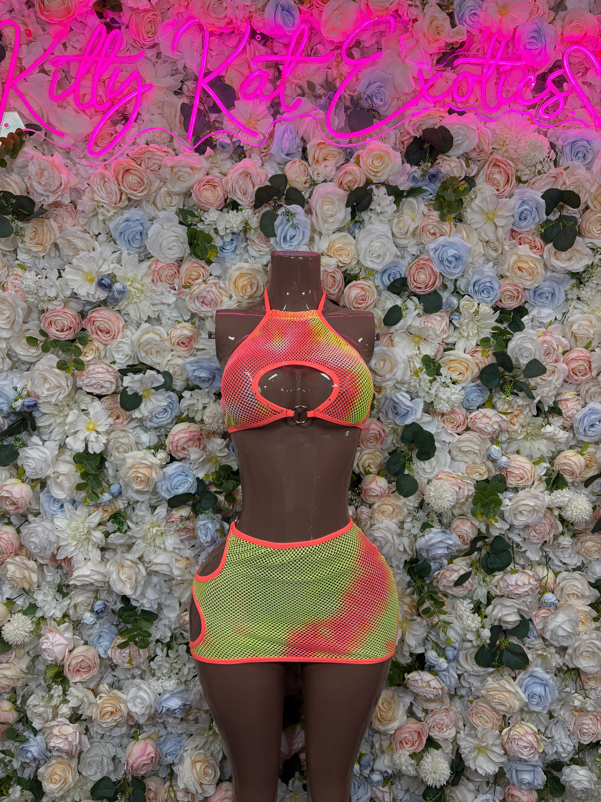 Orange keyhole bikini top with neon ring cutout and color-block mini skirt