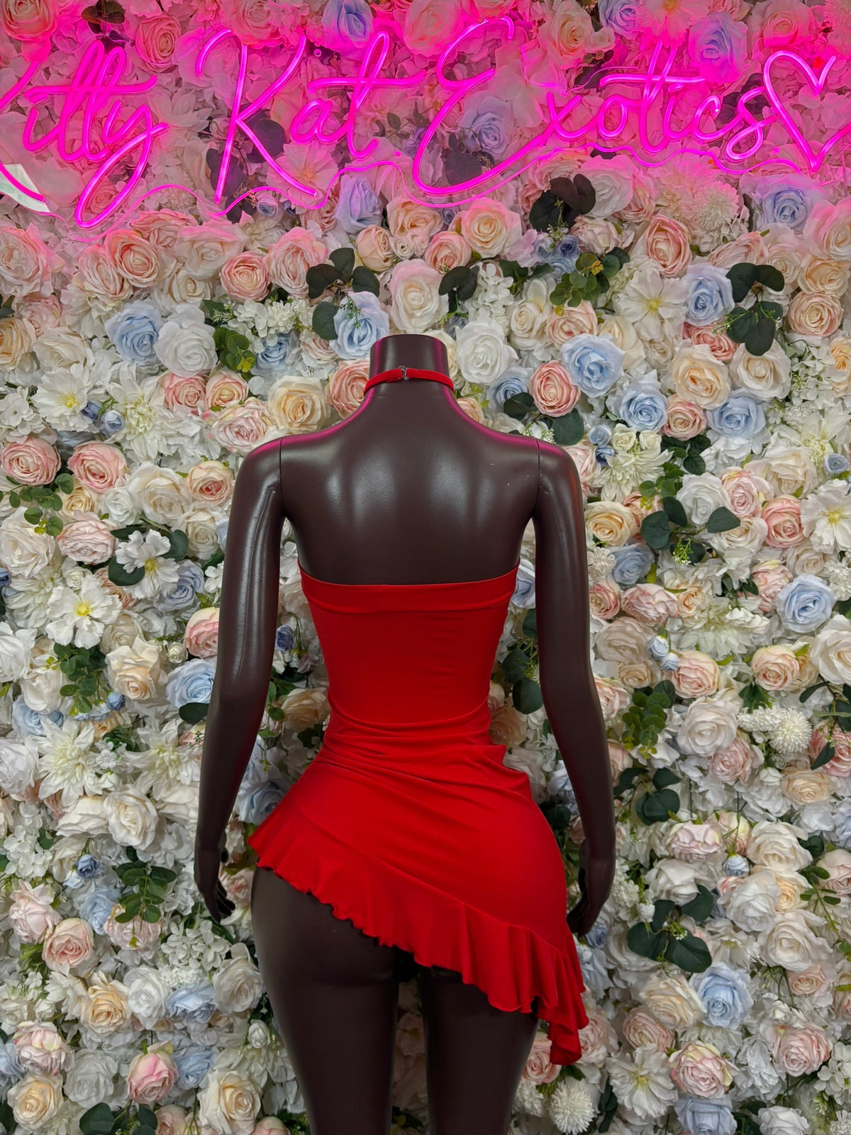 Red high-neck asymmetric mini dress with open back and ruffled hem