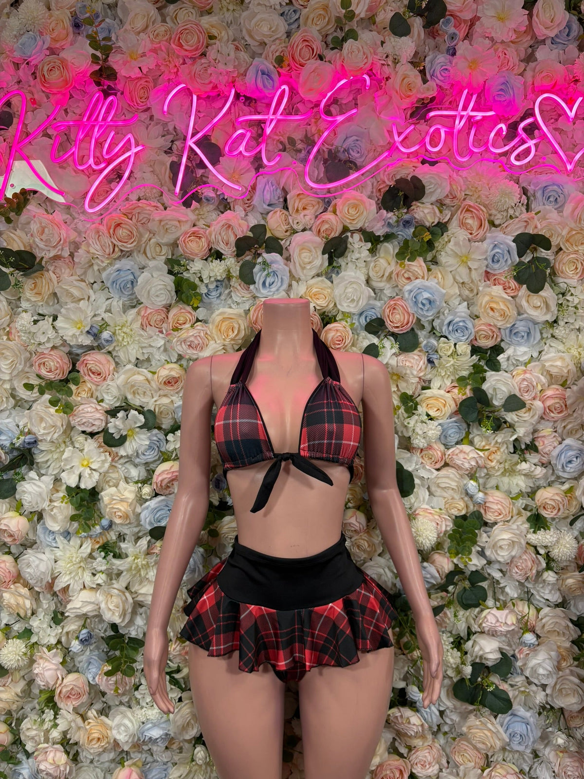 Red and black plaid halter top and mini skirt set on a mannequin