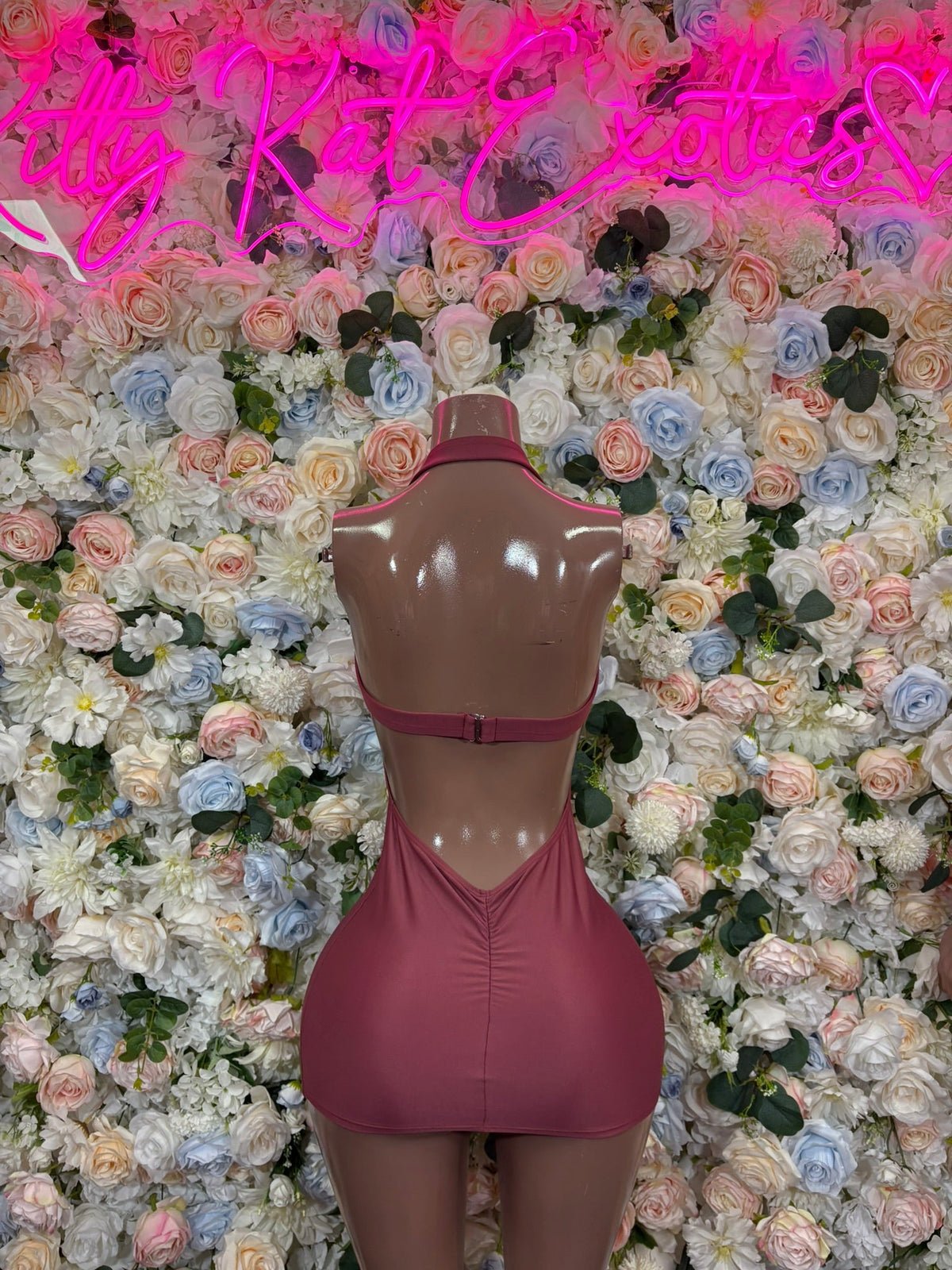 Mauve keyhole halter mini dress on mannequin, sleeveless with front cutout