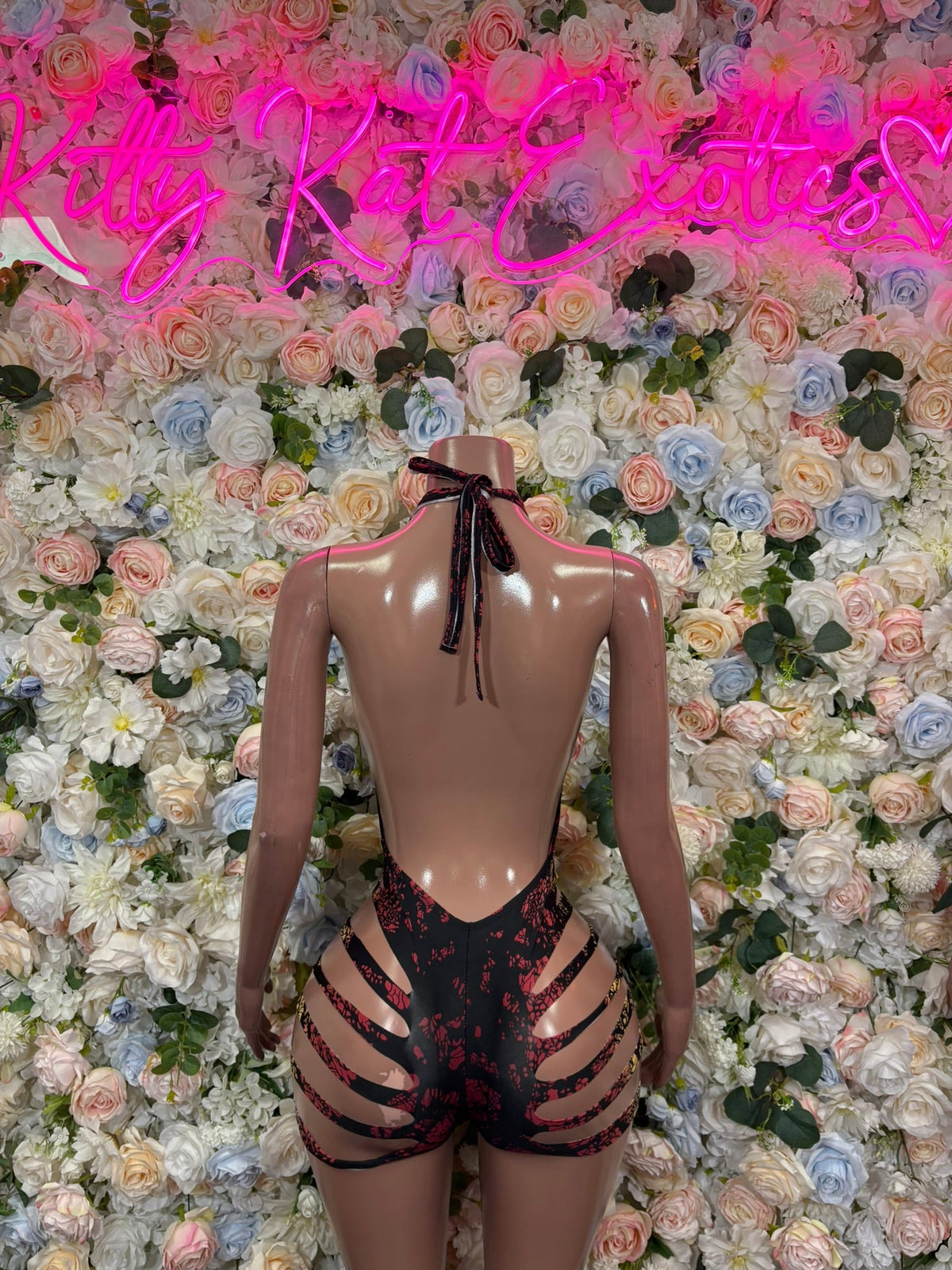 Black and gold cutout halter bodysuit with open back and strappy waistband