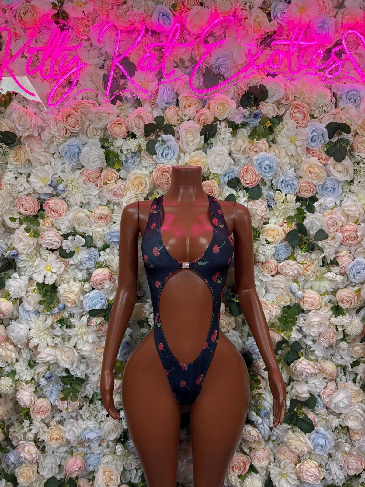 Navy cherry-print cross-back cutout bodysuit on mannequin, front with oval cutouts