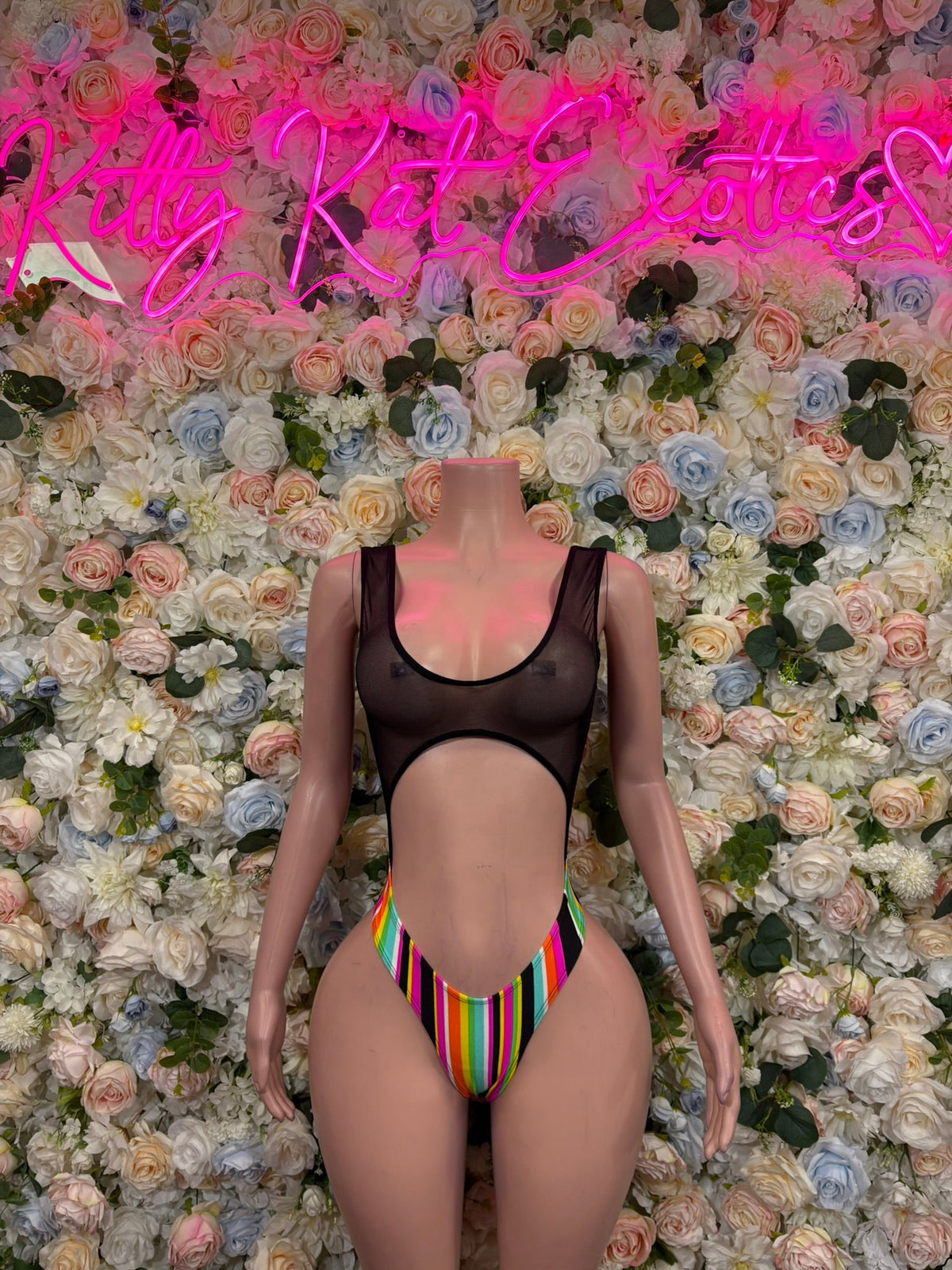 Black cutout bodysuit with rainbow-striped V front panel on mannequin