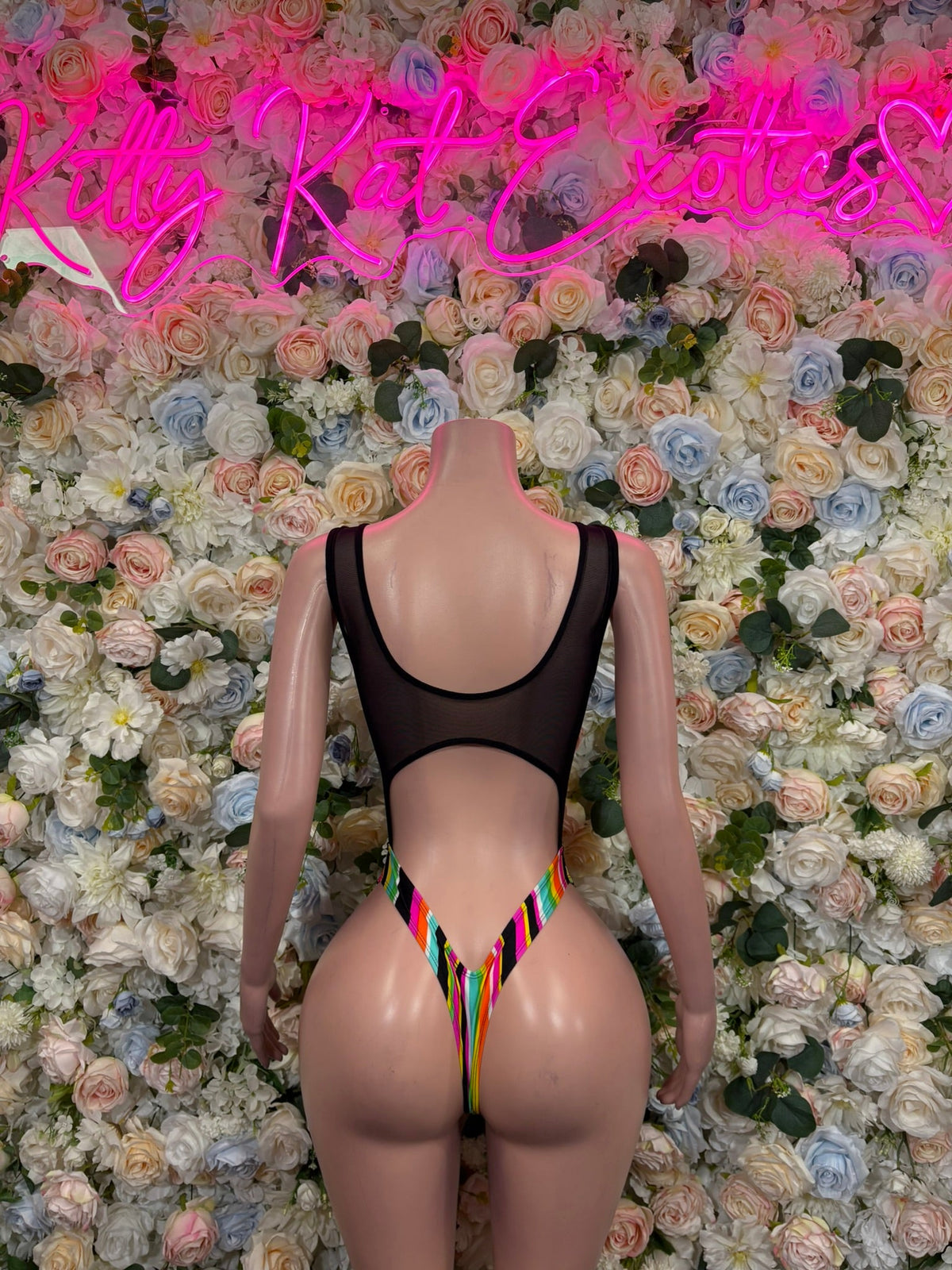Black bodysuit with rainbow V-cutout panel and open back on a mannequin