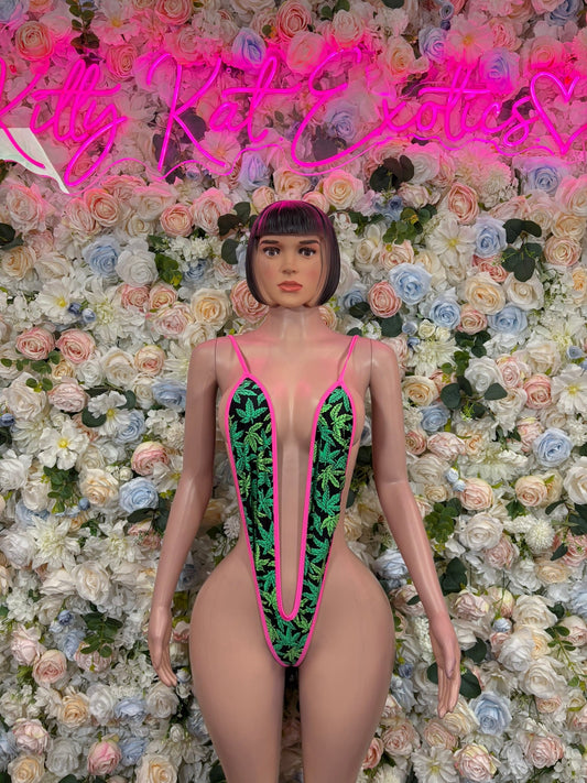 Deep-plunge slingshot bodysuit in pink with green graphic panels, front view