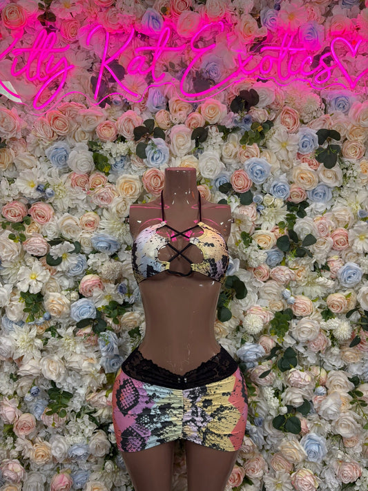 Pastel snake-print halter top and lace-trim mini skirt set on mannequin, front view.