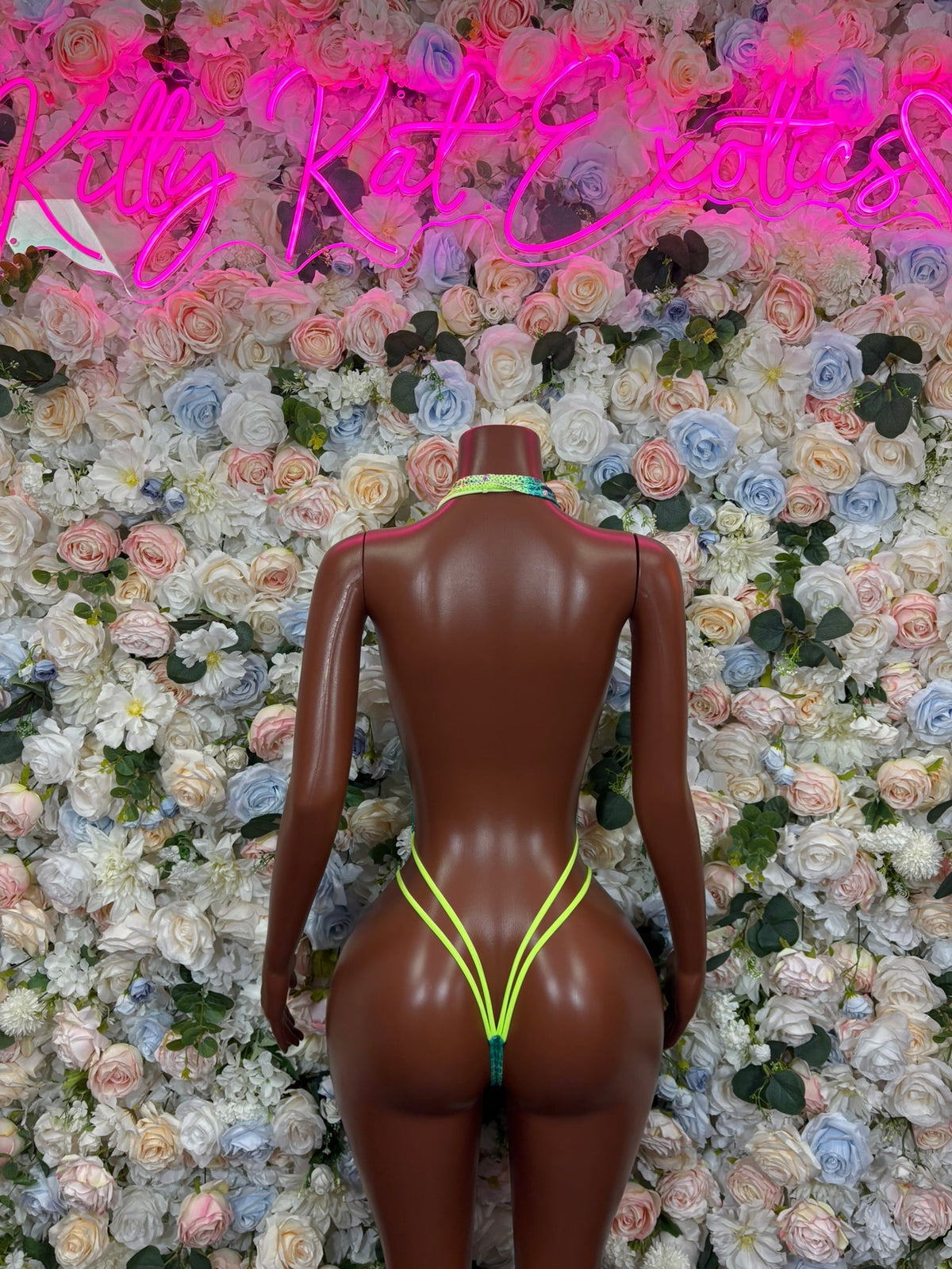 Turquoise slingshot bodysuit back view with yellow-trim V thong cut