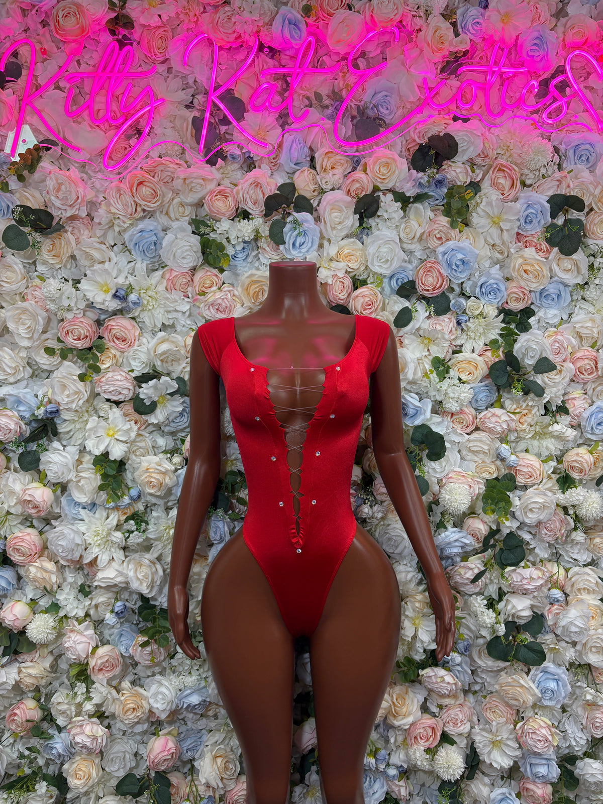 Red long-sleeve bodysuit with front center button detail