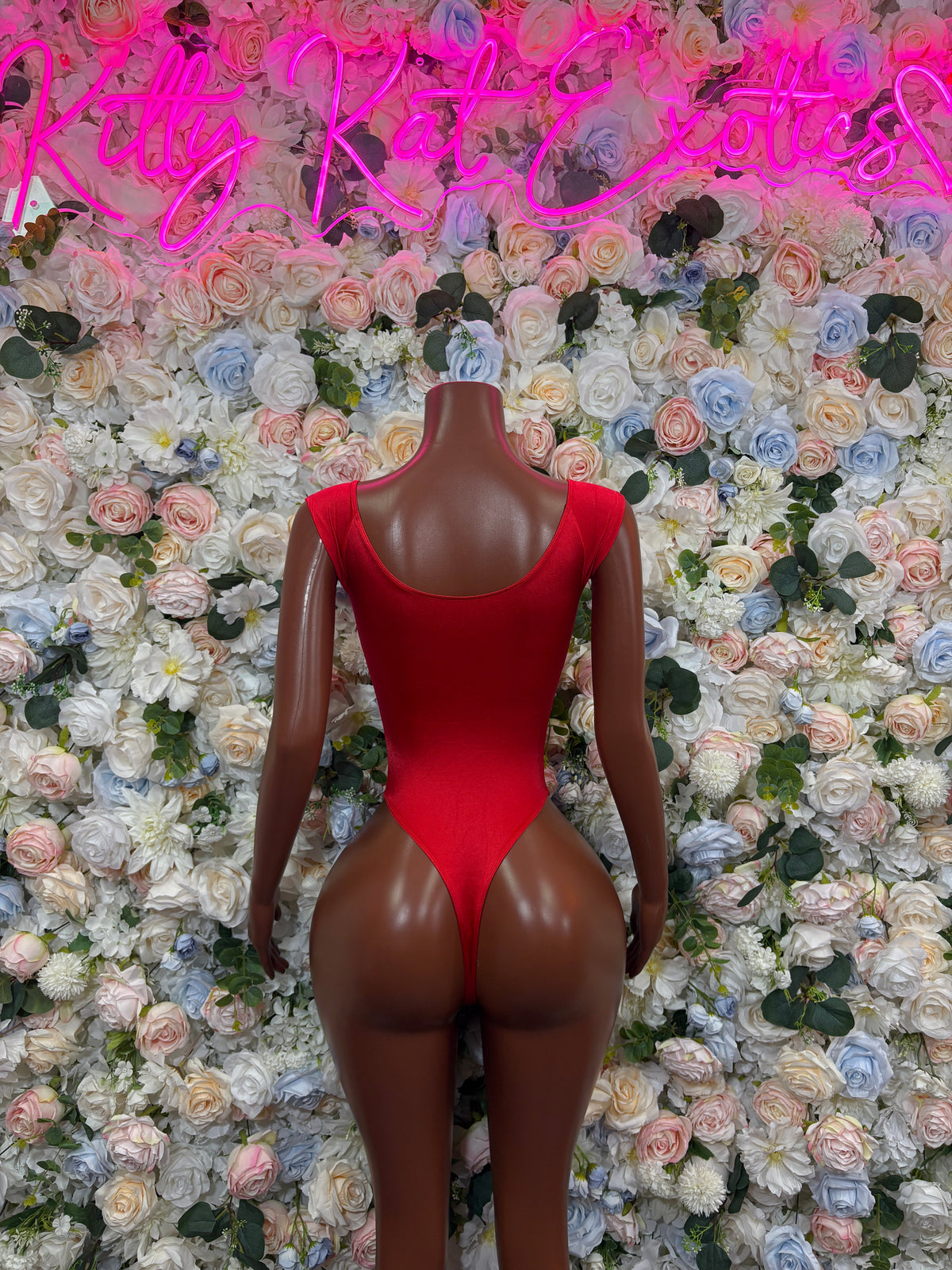 Red long-sleeve bodysuit with scoop neck and fitted leg